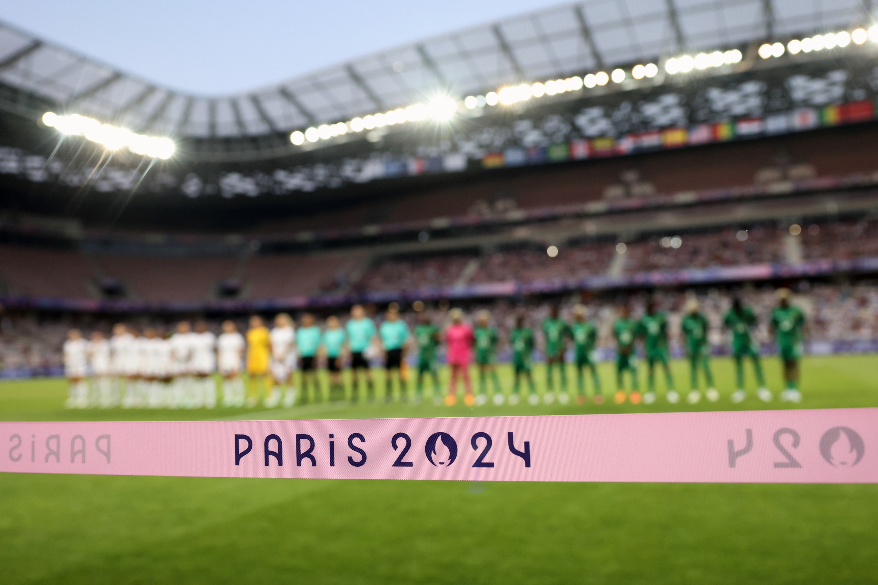 NICE, FRANCE - JULY 25: Paris 2024 Olympic branding is seen as the teams line up for the National anthems during the Women's group B match between United States and Zambia during the Olympic Games Paris 2024 at Stade de Nice on July 25, 2024 in Nice, France. (Photo by Marc Atkins/Getty Images)