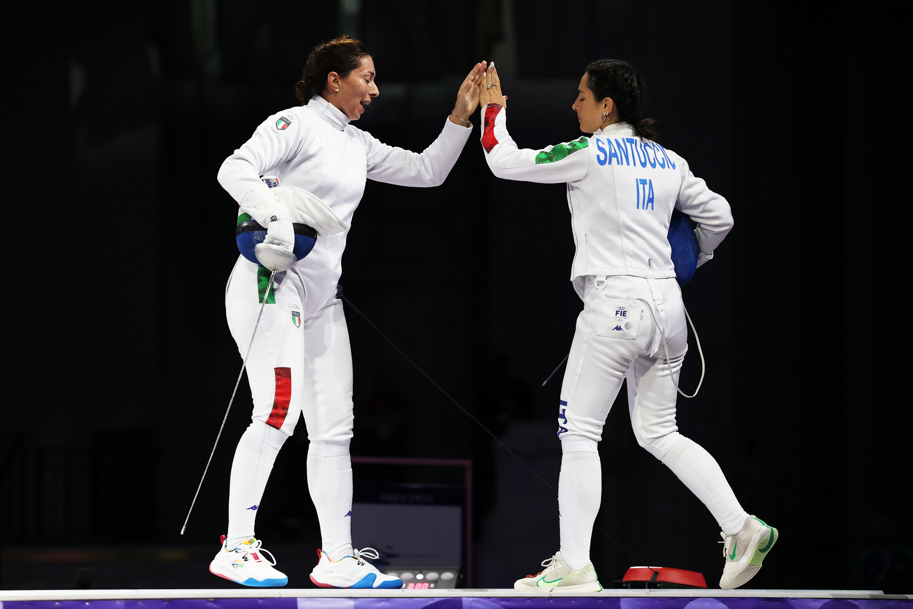 PARIS, FRANCE - JULY 30: Mara Navarria (L) interacts with teammate Alberta Santuccio of Team Italy during the Fencing Women's Epee Team Gold Medal match between Team France and Team Ital on day four of the Olympic Games Paris 2024 at Grand Palais on July 30, 2024 in Paris, France. (Photo by Elsa/Getty Images)