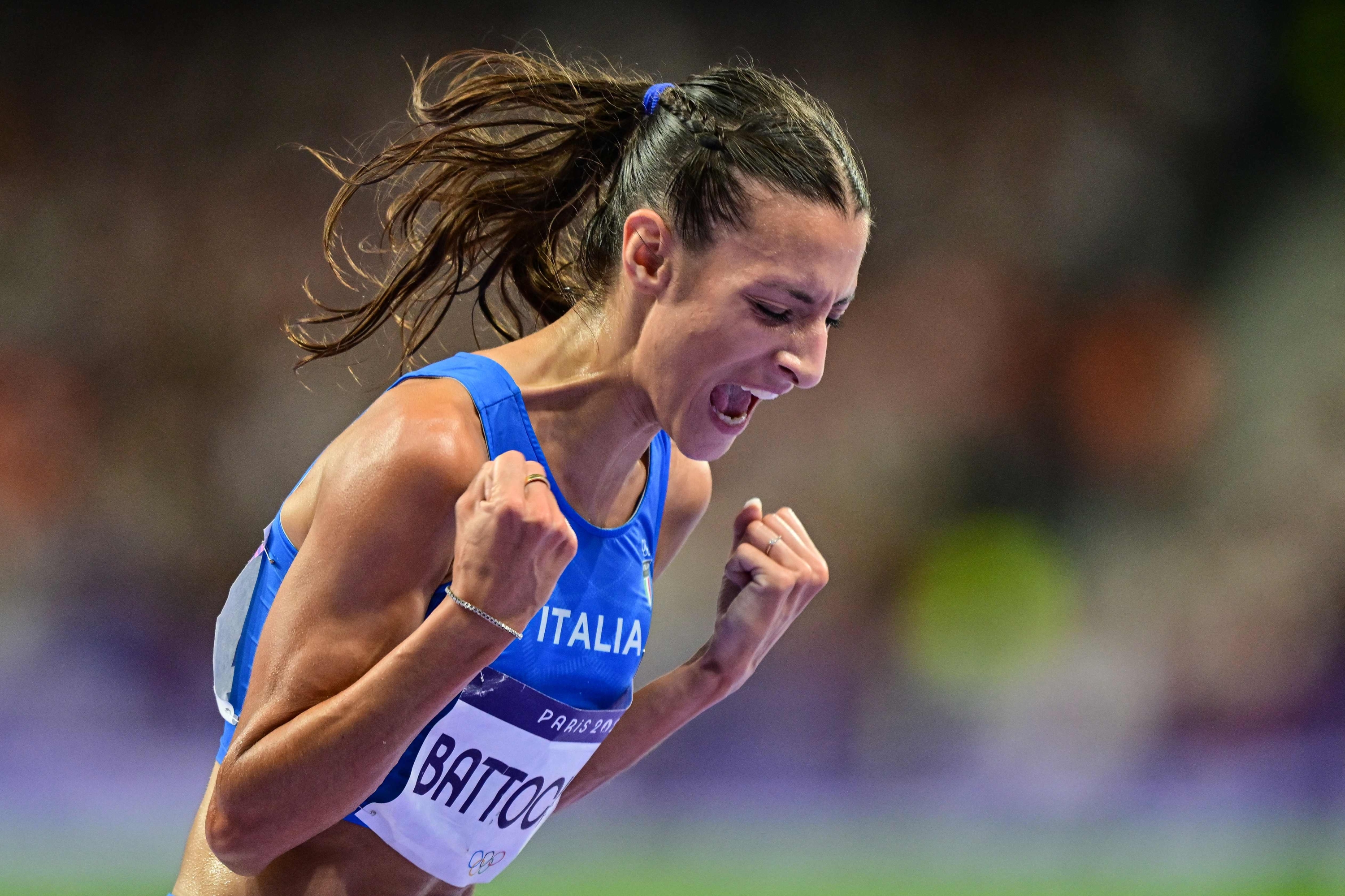 Second placed Italy's Nadia Battocletti celebrates after the women's 10000m final of the athletics event at the Paris 2024 Olympic Games at Stade de France in Saint-Denis, north of Paris, on August 9, 2024. (Photo by Martin  BERNETTI / AFP)