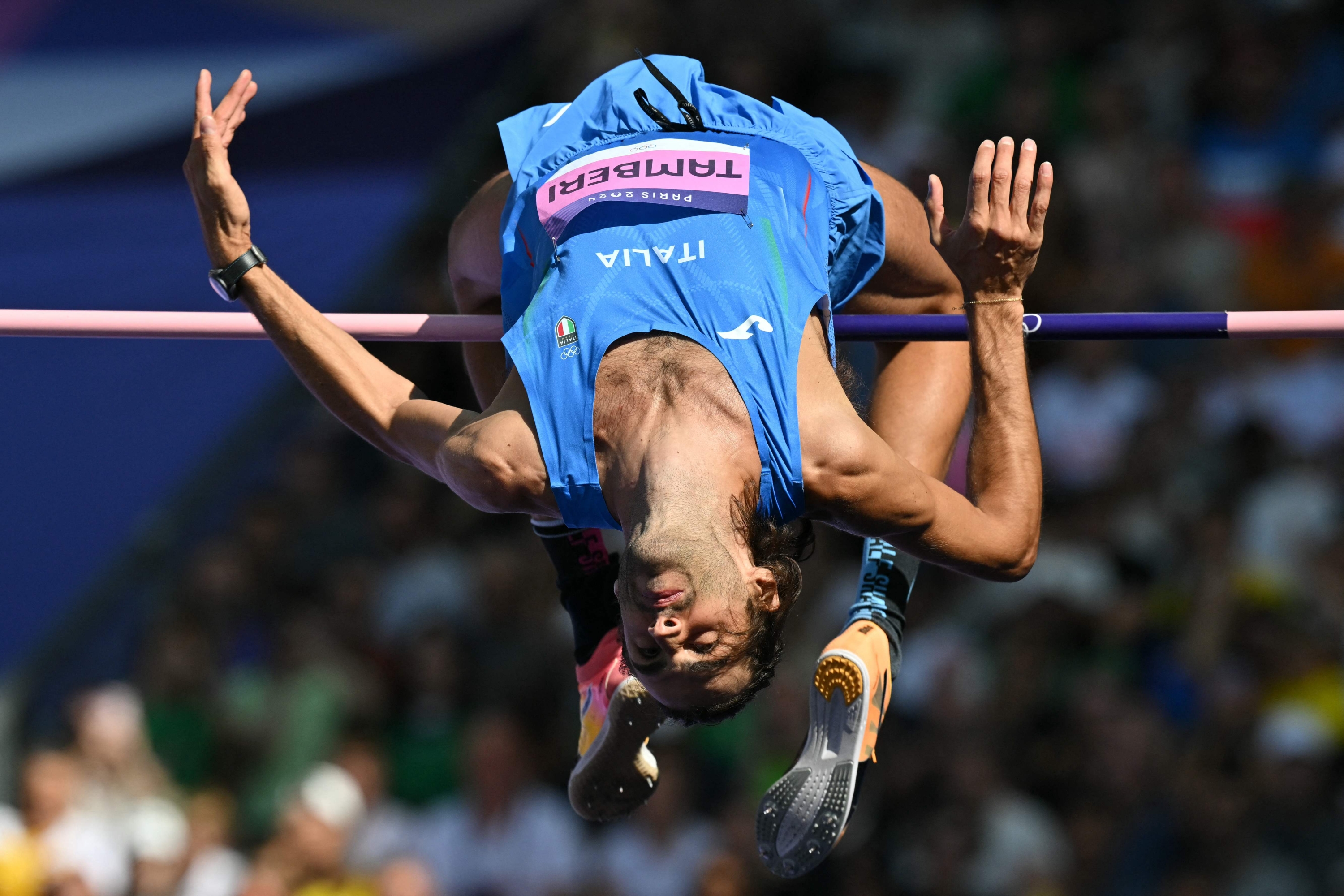 TOPSHOT - Italy's Gianmarco Tamberi competes in the men's high jump qualification of the athletics event at the Paris 2024 Olympic Games at Stade de France in Saint-Denis, north of Paris, on August 7, 2024. (Photo by Andrej ISAKOVIC / AFP)