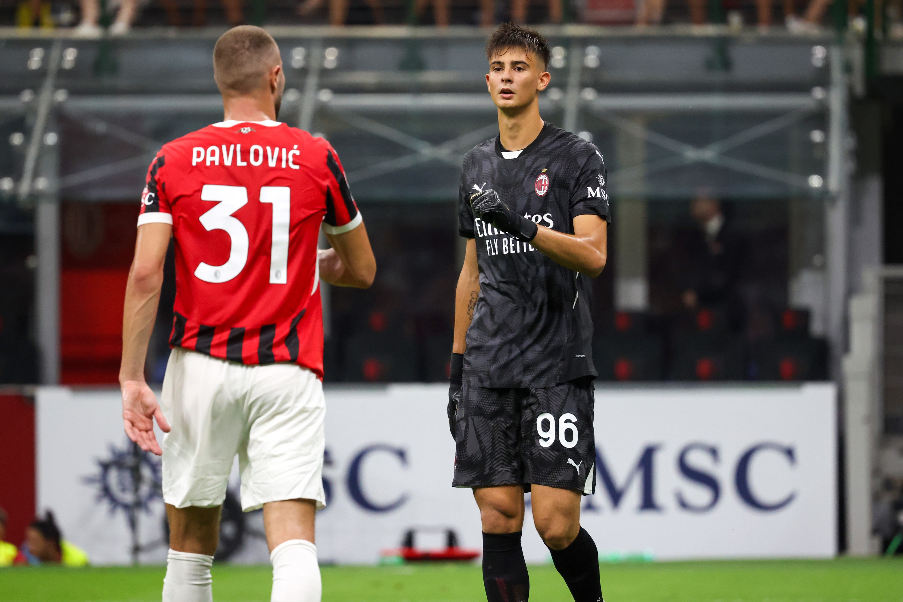 MILAN, ITALY - AUGUST 13: (L-R) Strahinja Pavlovi? cheers Lorenzo Torriani Goalkeeper of AC Milan in action during the Trofeo Berlusconi match between AC Milan and Monza on August 13, 2024 in Milan, Italy. (Photo by Sara Cavallini/AC Milan via Getty Images)