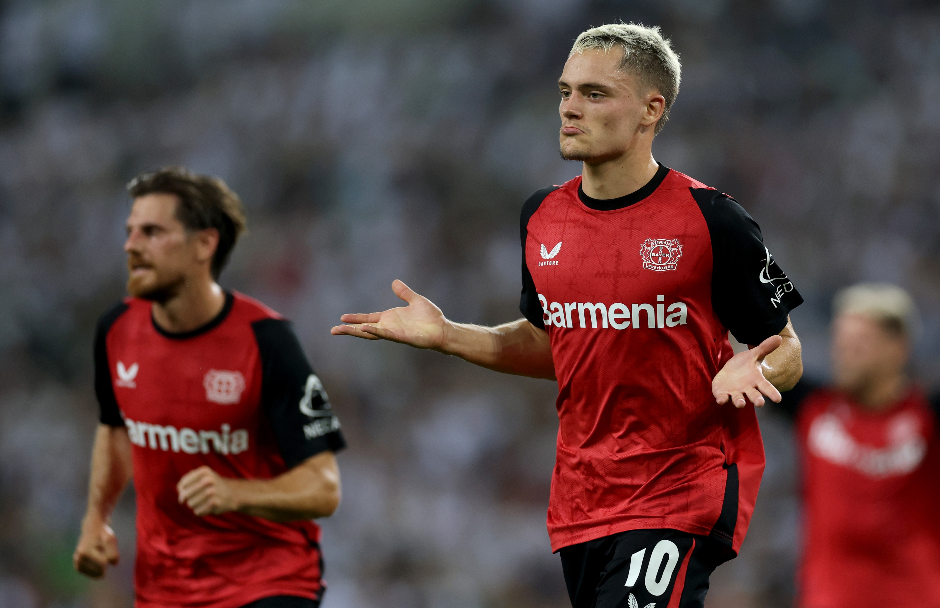 MOENCHENGLADBACH, GERMANY - AUGUST 23: Florian Wirtz of Bayer Leverkusen celebrates after scoring his teams second goal during the Bundesliga match between Borussia Mönchengladbach and Bayer 04 Leverkusen at Borussia-Park on August 23, 2024 in Moenchengladbach, Germany. (Photo by Lars Baron/Getty Images)