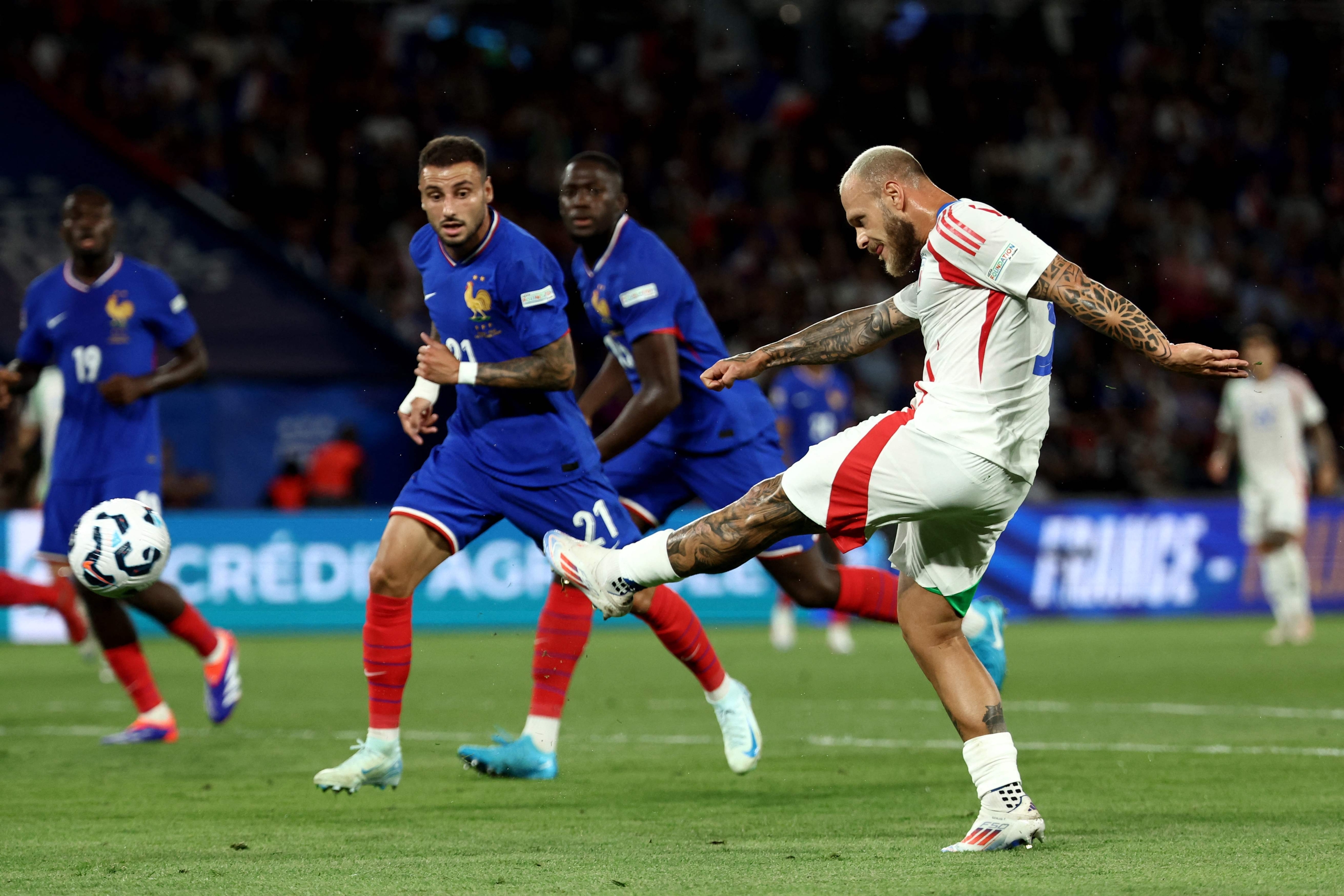 Italy's defender #03 Federico Dimarco kicks the ball and scores during the UEFA Nations League Group A2 football match between France and Italy at the Parc des Princes in Paris on September 6, 2024. (Photo by Franck FIFE / AFP)