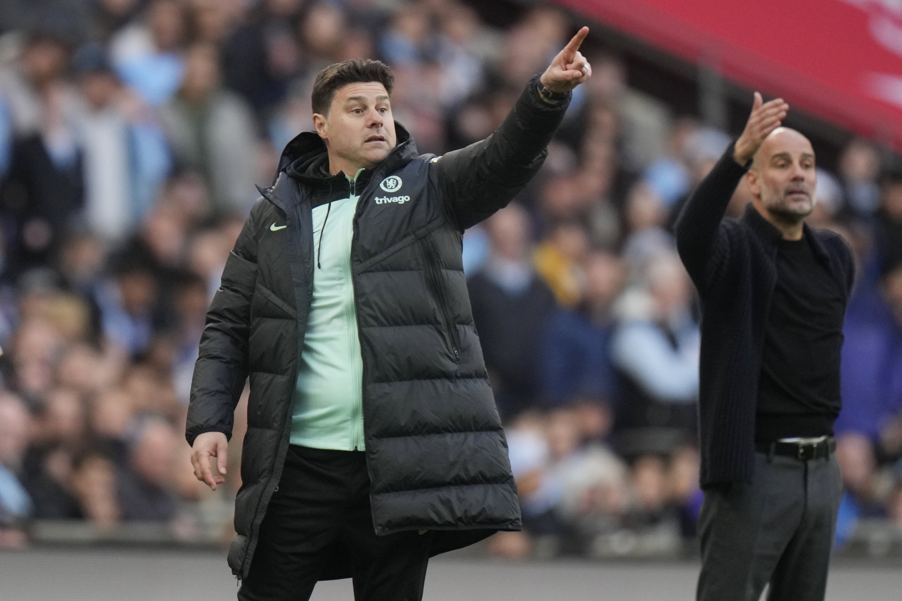 FILE - Chelsea's head coach Mauricio Pochettino, left, and Manchester City's head coach Pep Guardiola gesture during the English FA Cup semifinal soccer match between Manchester City and Chelsea at Wembley stadium in London, Saturday, April 20, 2024. (AP Photo/Alastair Grant)