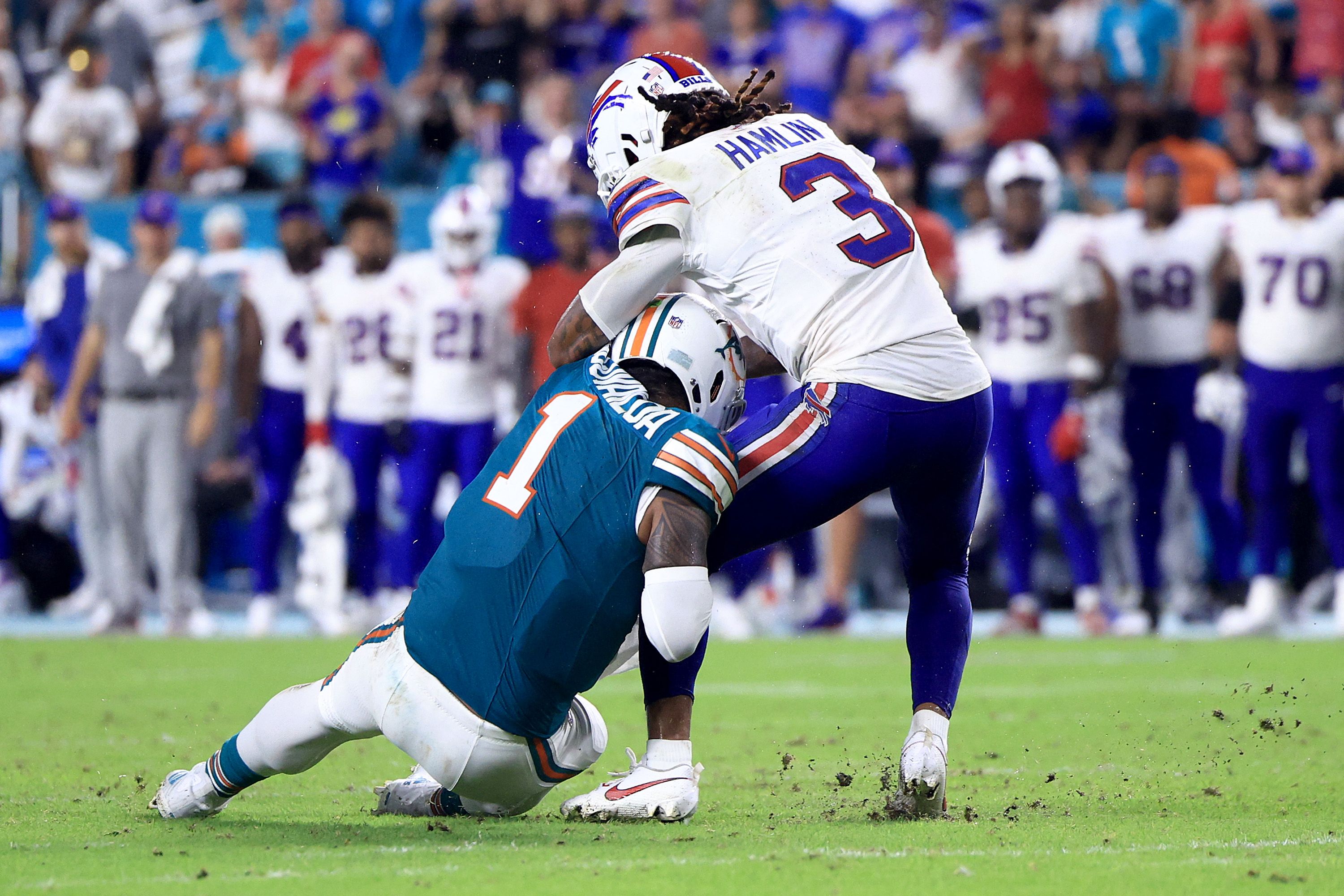 MIAMI GARDENS, FLORIDA - SEPTEMBER 12: Tua Tagovailoa #1 of the Miami Dolphins collides with Damar Hamlin #3 of the Buffalo Bills during the third quarter in the game at Hard Rock Stadium on September 12, 2024 in Miami Gardens, Florida.   Carmen Mandato/Getty Images/AFP (Photo by Carmen Mandato / GETTY IMAGES NORTH AMERICA / Getty Images via AFP)