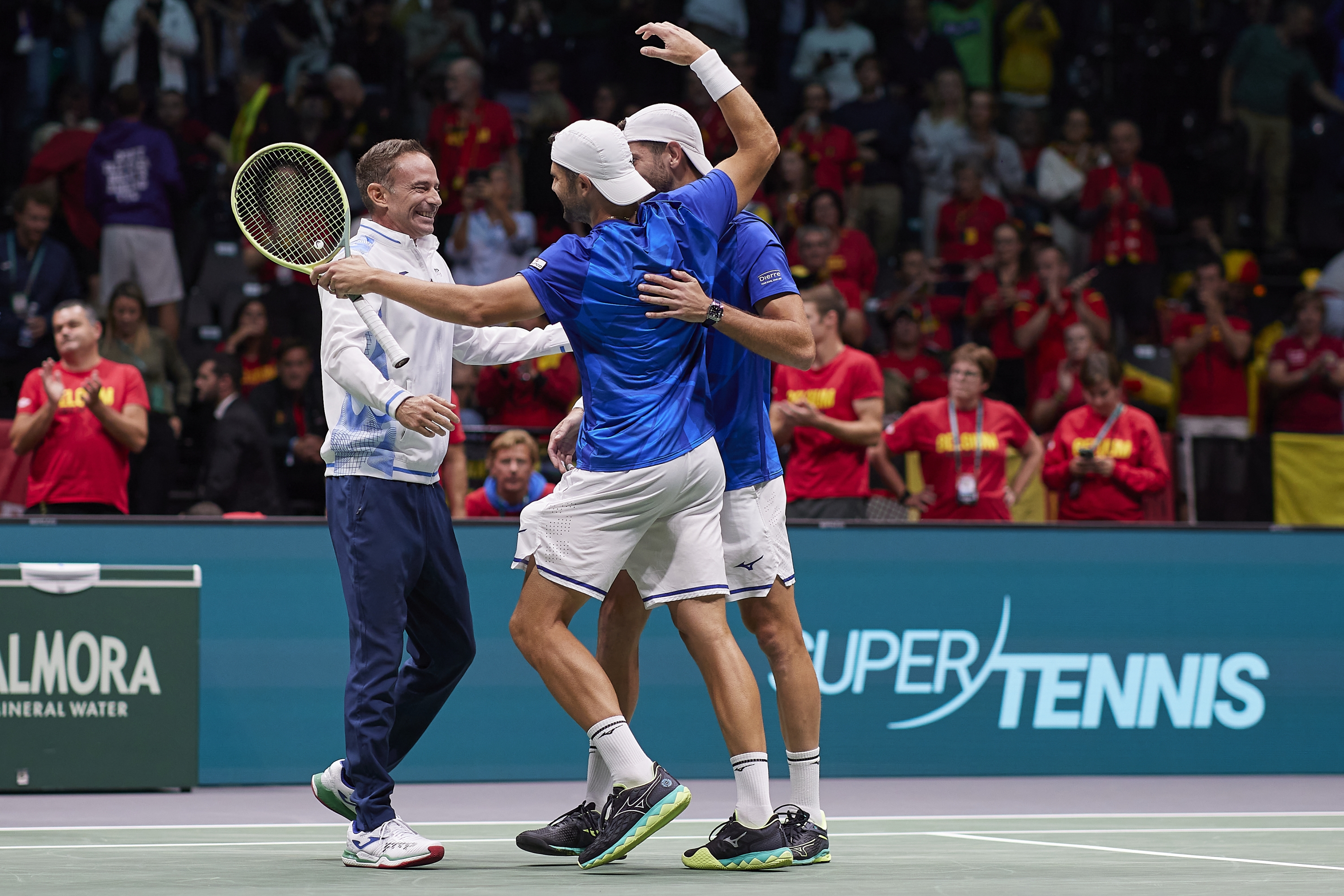 BOLOGNA, ITALY - SEPTEMBER 13: Filippo Volandri, Andrea Vavassori and Simone Bolelli of Italy celebrates winning the match against Belgium during 2024 Davis Cup Finals Group Stage Bologna match between Italy and Belgium at Unipol Arena on September 13, 2024 in Bologna, Italy. (Photo by Emmanuele Ciancaglini/Getty Images for ITF)