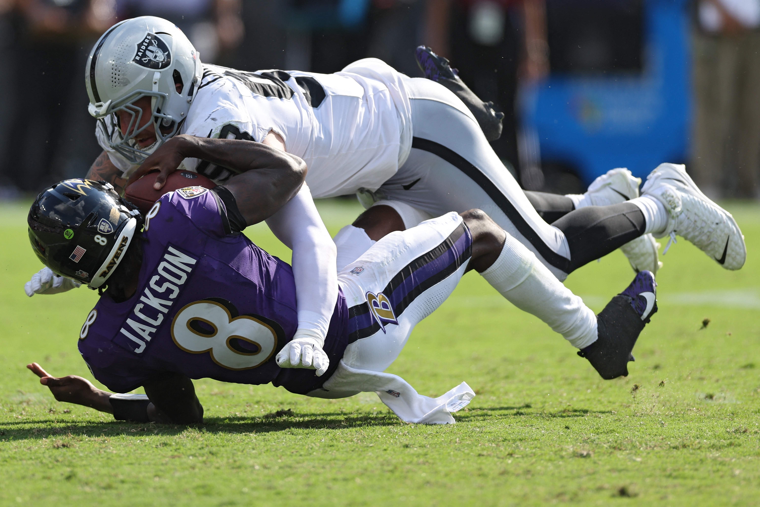 BALTIMORE, MARYLAND - SEPTEMBER 15: Maxx Crosby #98 of the Las Vegas Raiders sacks Lamar Jackson #8 of the Baltimore Ravens during the fourth quarter at M&T Bank Stadium on September 15, 2024 in Baltimore, Maryland.   Patrick Smith/Getty Images/AFP (Photo by Patrick Smith / GETTY IMAGES NORTH AMERICA / Getty Images via AFP)