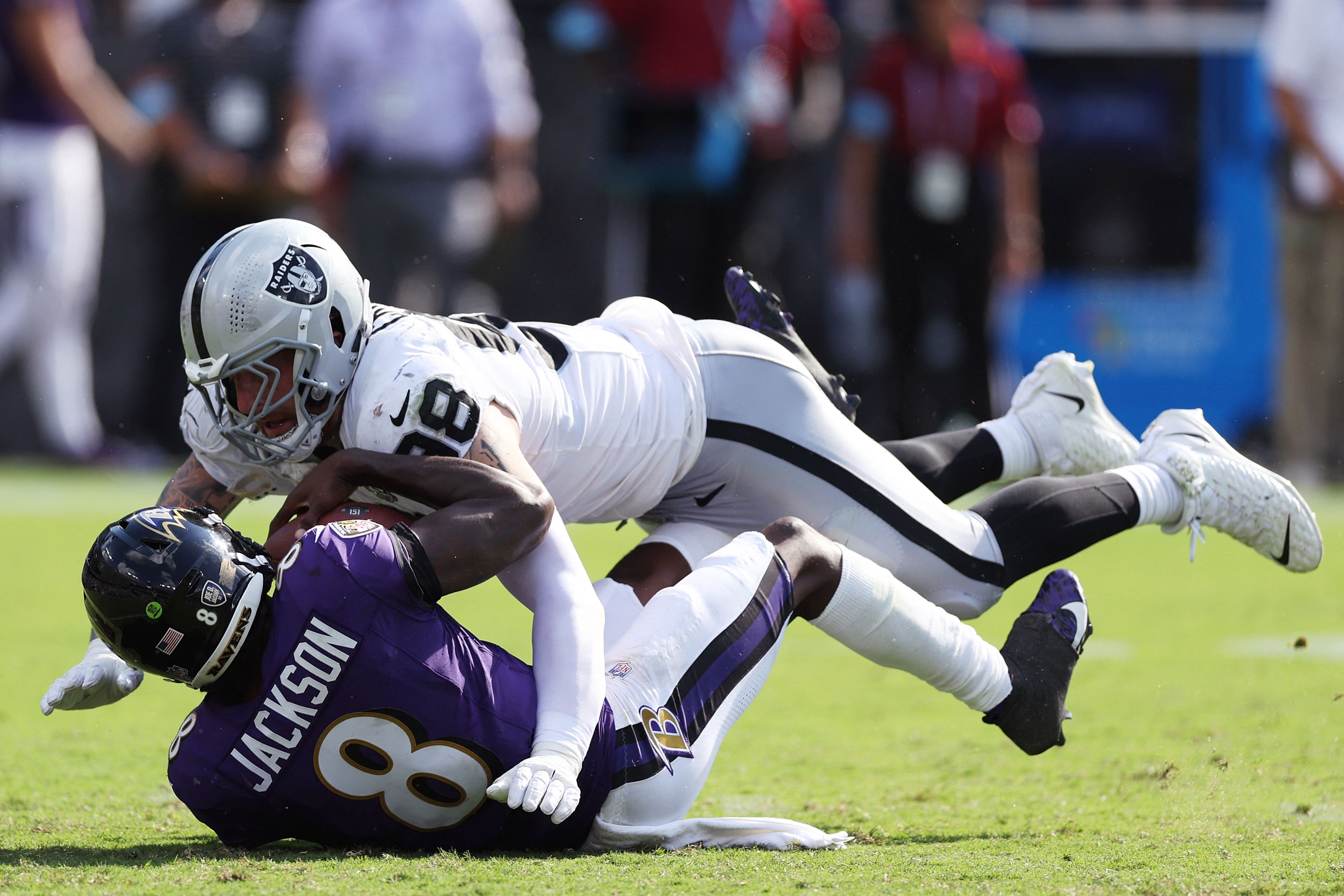 BALTIMORE, MARYLAND - SEPTEMBER 15: Maxx Crosby #98 of the Las Vegas Raiders sacks Lamar Jackson #8 of the Baltimore Ravens during the fourth quarter at M&T Bank Stadium on September 15, 2024 in Baltimore, Maryland.   Patrick Smith/Getty Images/AFP (Photo by Patrick Smith / GETTY IMAGES NORTH AMERICA / Getty Images via AFP)