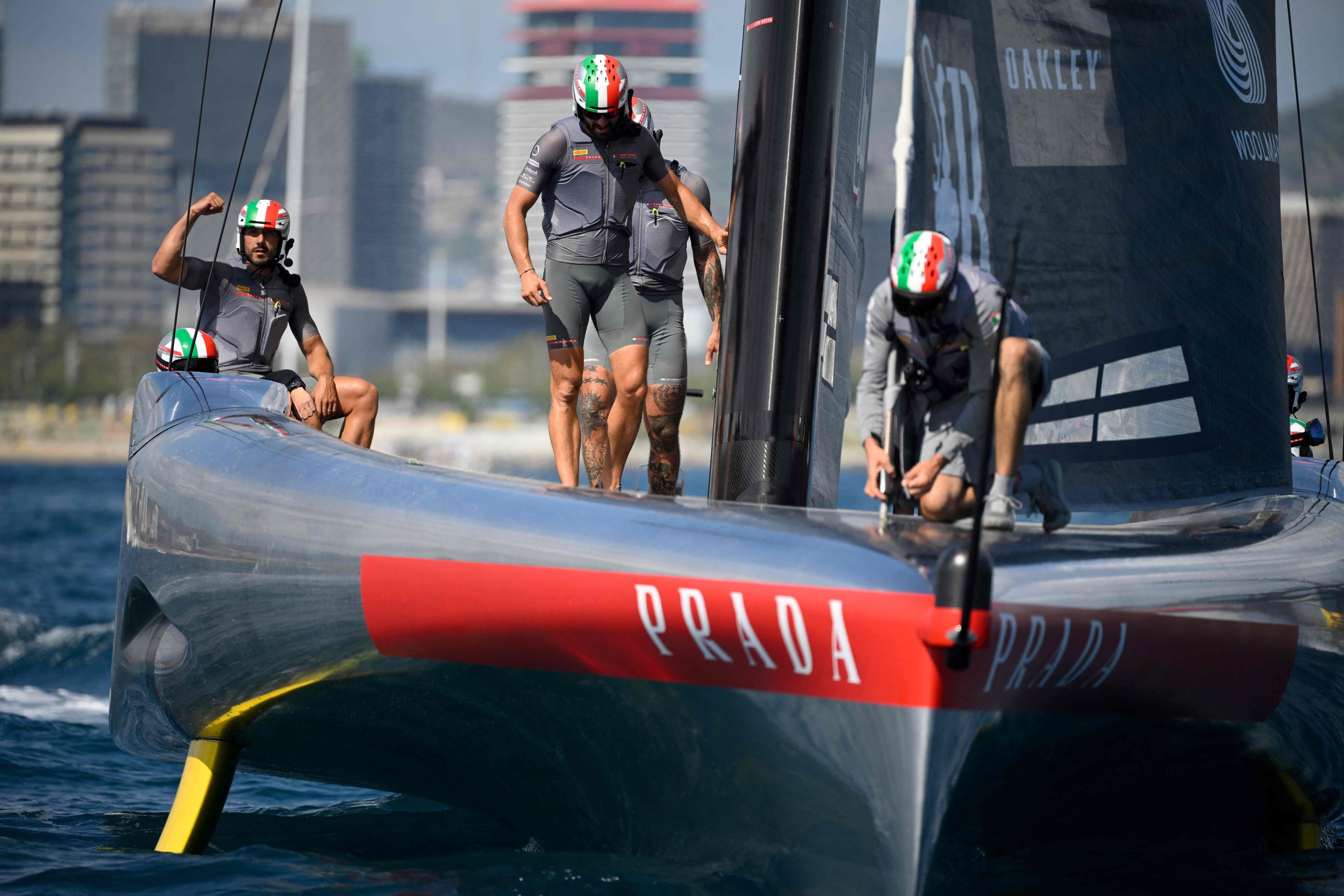 Italy's Luna Rossa Prada Pirelli team members celebrate after winning on the fifth day of the 37th America's Cup-Luis Vuitton semi-finals race, off the coast of Barcelona on September 19, 2024. (Photo by Josep LAGO / AFP)