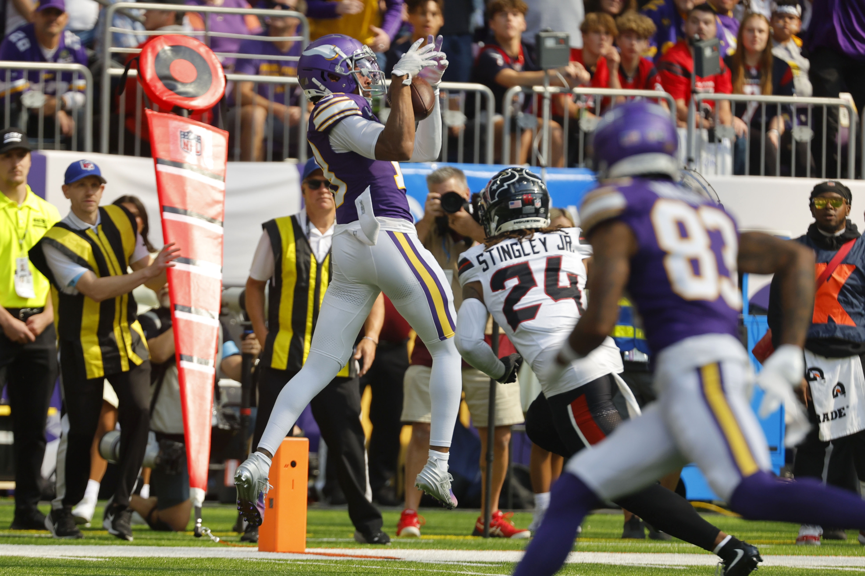 Minnesota Vikings wide receiver Justin Jefferson, left, catches a pass over Houston Texans cornerback Derek Stingley Jr. (24) during the first half of an NFL football game, Sunday, Sept. 22, 2024, in Minneapolis. (AP Photo/Bruce Kluckhohn)