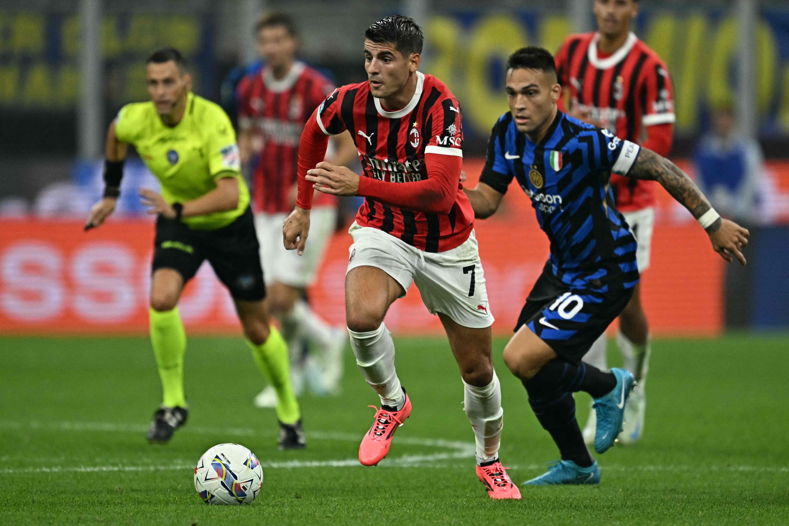 AC Milan's Spanish forward #07 Alvaro Morata fights for the ball with Inter Milan's Argentine forward #10 Lautaro Martinez during the Italian Serie A football match between Inter and AC Milan at San Siro stadium in Milan, on September 22, 2024. (Photo by Gabriel BOUYS / AFP)