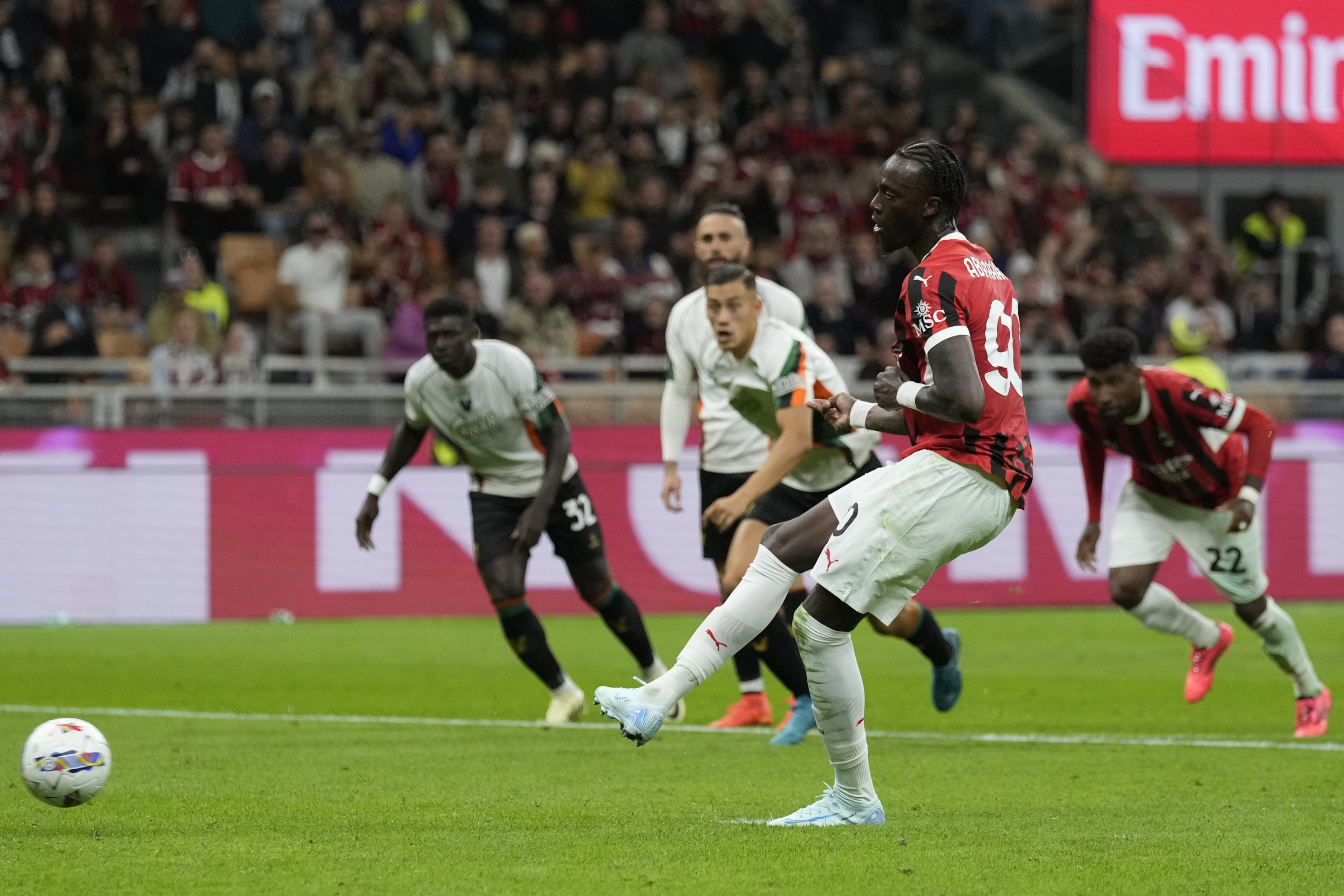 AC Milan's Tammy Abraham scores from a penalty kick during the Serie A soccer match between AC Milan and Venezia at the San Siro stadium in Milan, Italy, Saturday, Sept. 14, 2024. (AP Photo/Antonio Calanni)