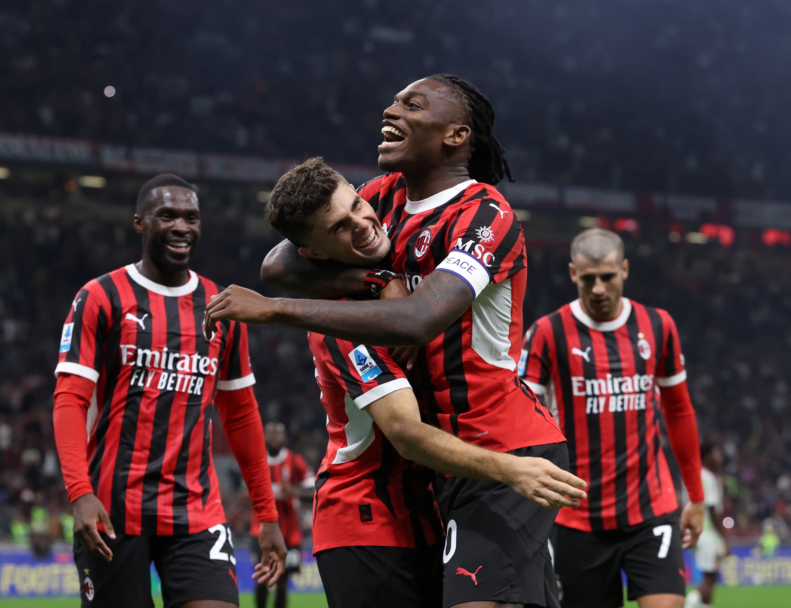 MILAN, ITALY - SEPTEMBER 27: Christian Pulisic of AC Milan celebrates with Rafael Leao after scoring the goal during the Serie match between Milan and Lecce at Stadio Giuseppe Meazza on September 27, 2024 in Milan, Italy. (Photo by Claudio Villa/AC Milan via Getty Images)