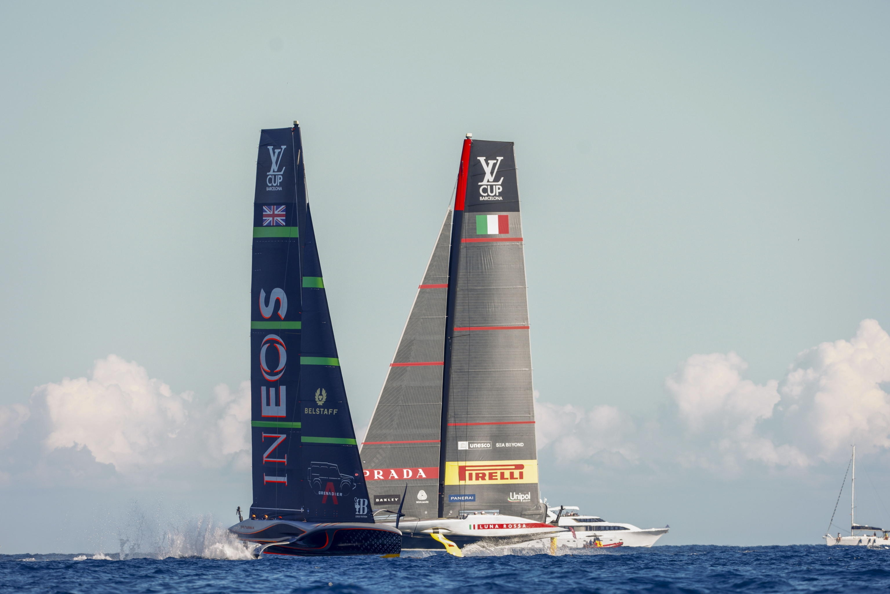 epa11630426 Team Luna Rossa Prada Pirelli (R) and team INEOS Britannia (L) compete during Day 2 of the 2024 Louis Vuitton Cup final in Barcelona, Spain, 28 September 2024. The winner of the Louis Vuitton Cup sailing competition determines the challenger in the 37th America's Cup to be held in October.  EPA/Quique Garcia