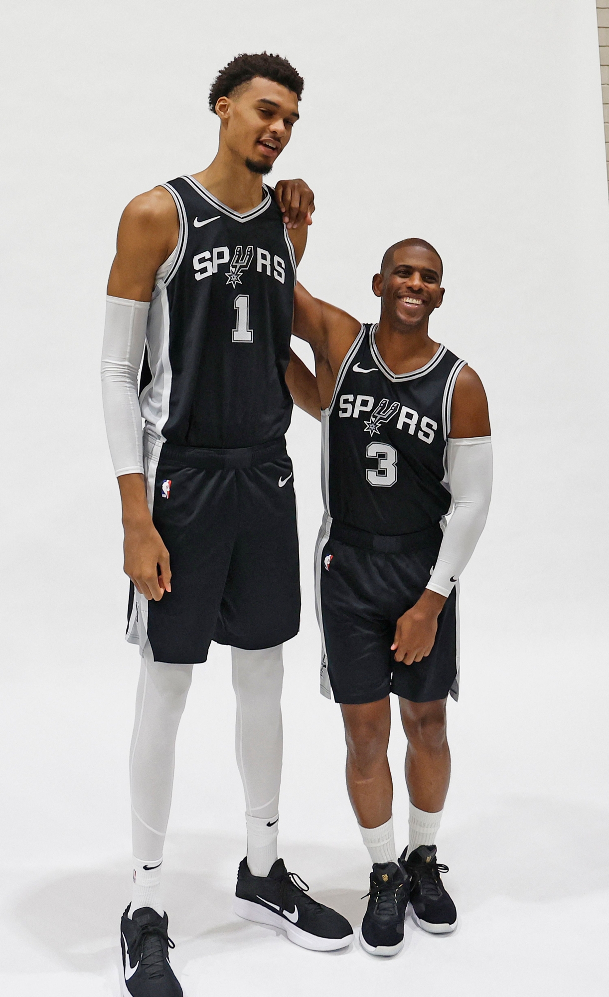 SAN ANTONIO, TX - SEPTEMBER 30: Victor Wembanyama #1 of the San Antonio Spurs and Chris Paul #3 prepare to have their photograph taken at the San Antonio Spurs Media Day at the Victory Capital Performance Center on September 30, 2024 in San Antonio, Texas. NOTE TO USER: User expressly acknowledges and agrees that, by downloading and or using this photograph, User is consenting to terms and conditions of the Getty Images License Agreement.   Ronald Cortes/Getty Images/AFP (Photo by Ronald Cortes / GETTY IMAGES NORTH AMERICA / Getty Images via AFP)