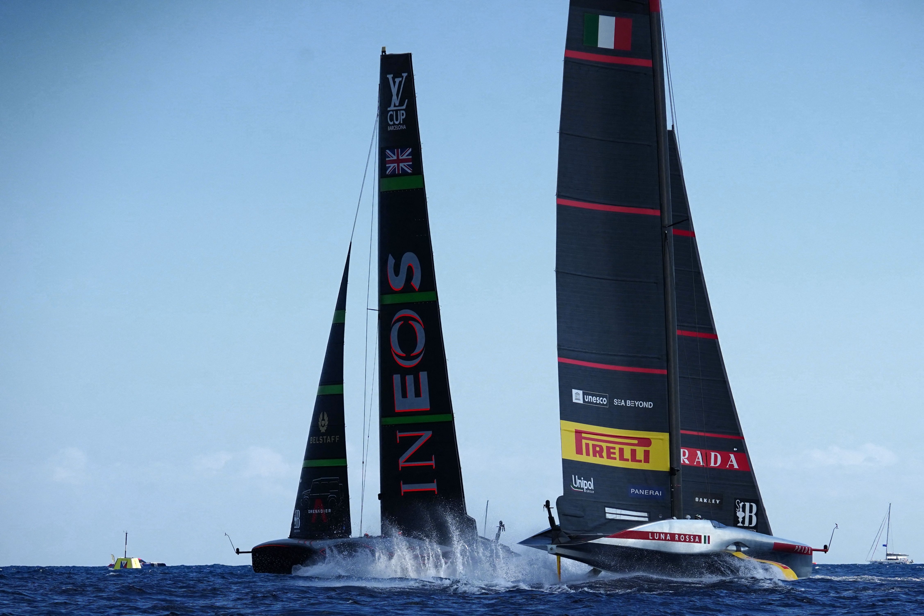 Britain's Ineos Britannia (L) competes against Italy's Luna Rossa Prada Pirelli during the Louis Vuitton Cup final on day seven of the 37th America's Cup finals, off the coast of Barcelona on October 4, 2024. (Photo by Manaure Quintero / AFP)