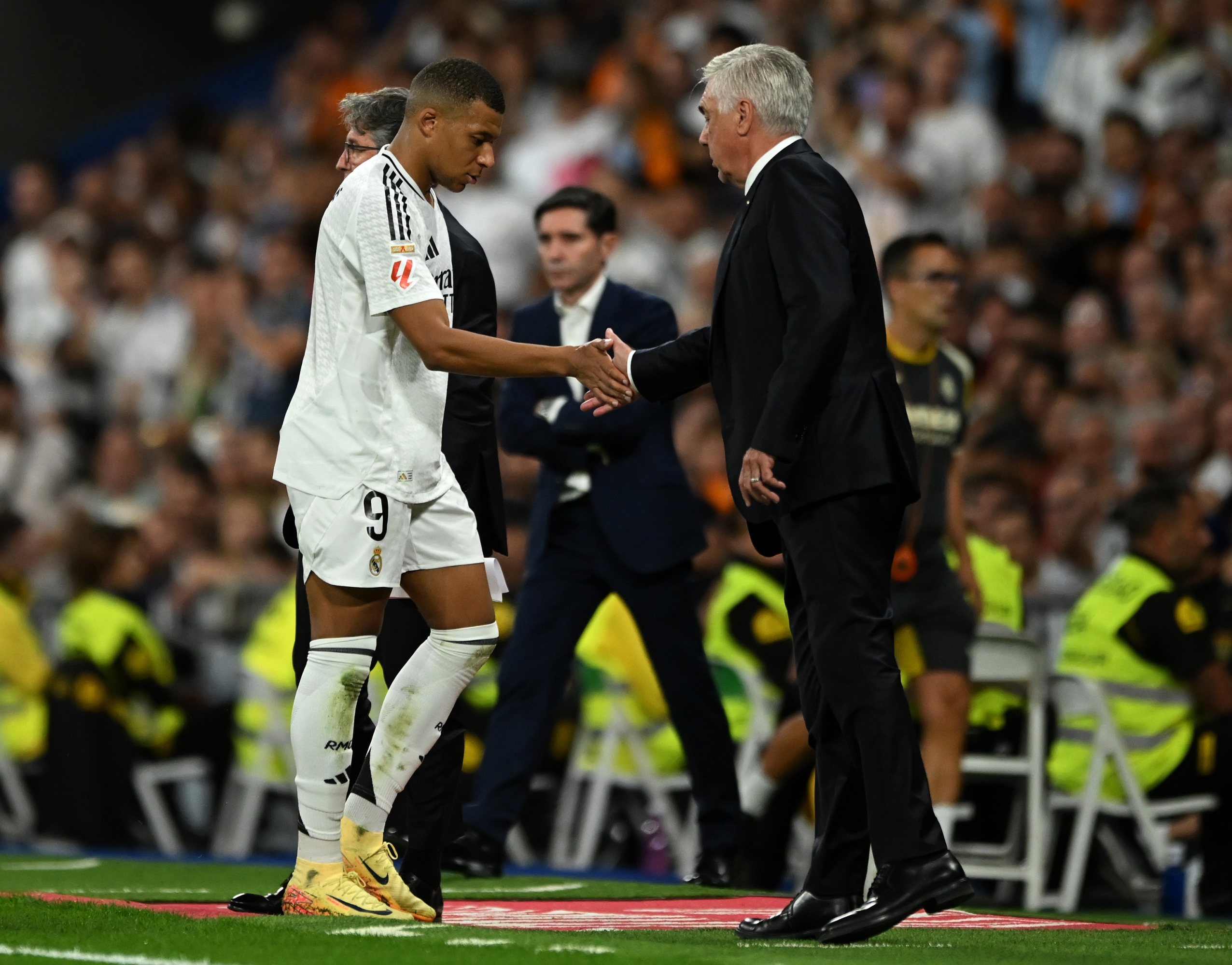 MADRID, SPAIN - OCTOBER 05: Kylian Mbappe of Real Madrid interacts with Carlo Ancelotti, Head Coach of Real Madrid, as he is substituted during the LaLiga match between Real Madrid CF and Villarreal CF  at Estadio Santiago Bernabeu on October 05, 2024 in Madrid, Spain. (Photo by Denis Doyle/Getty Images)