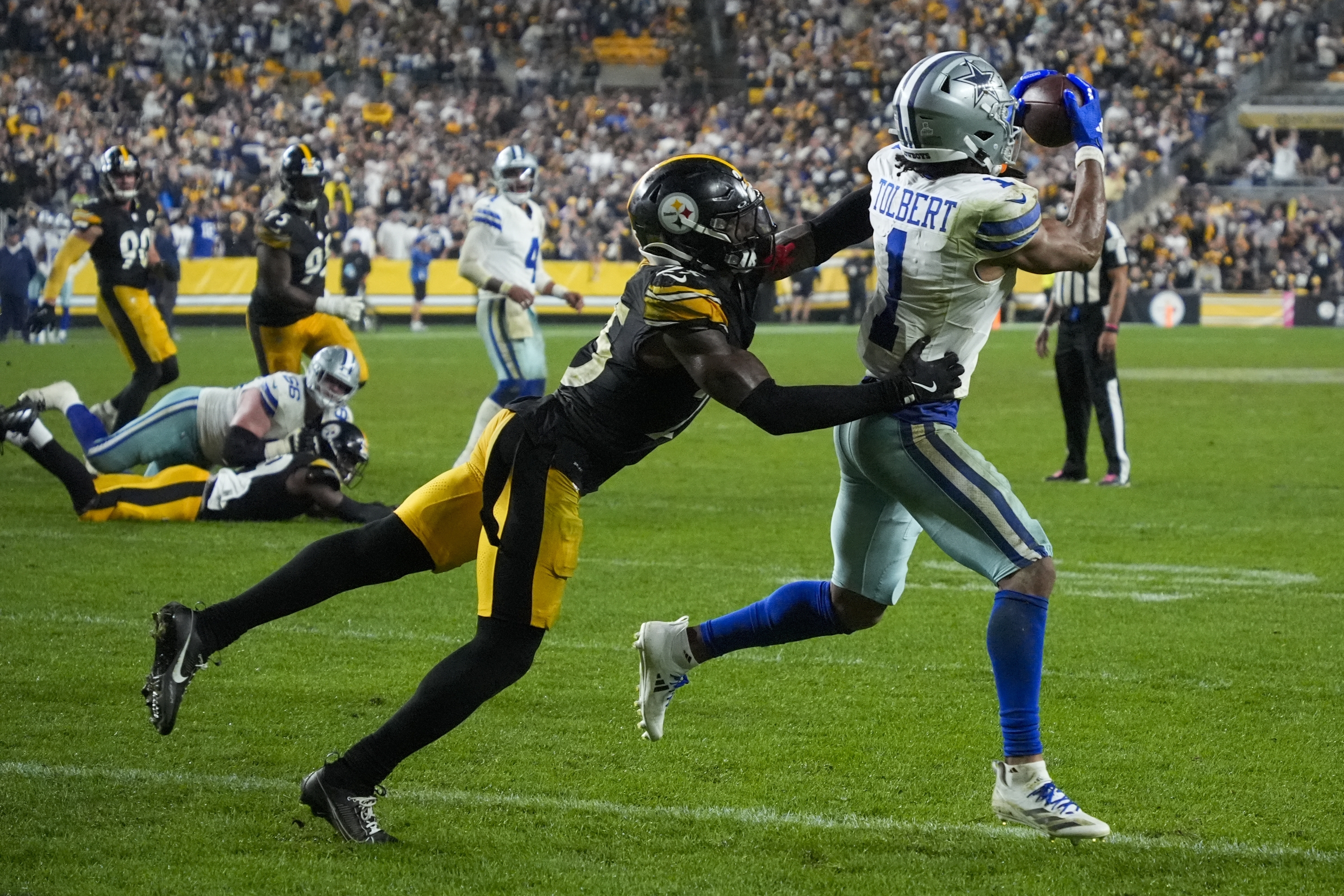 Dallas Cowboys wide receiver Jalen Tolbert (1) makes a touchdown catch as Pittsburgh Steelers safety DeShon Elliott tries to stop him during the second half of an NFL football game, early Monday, Oct. 7, 2024, in Pittsburgh. The Cowboys won 20-17. (AP Photo/Gene J. Puskar)