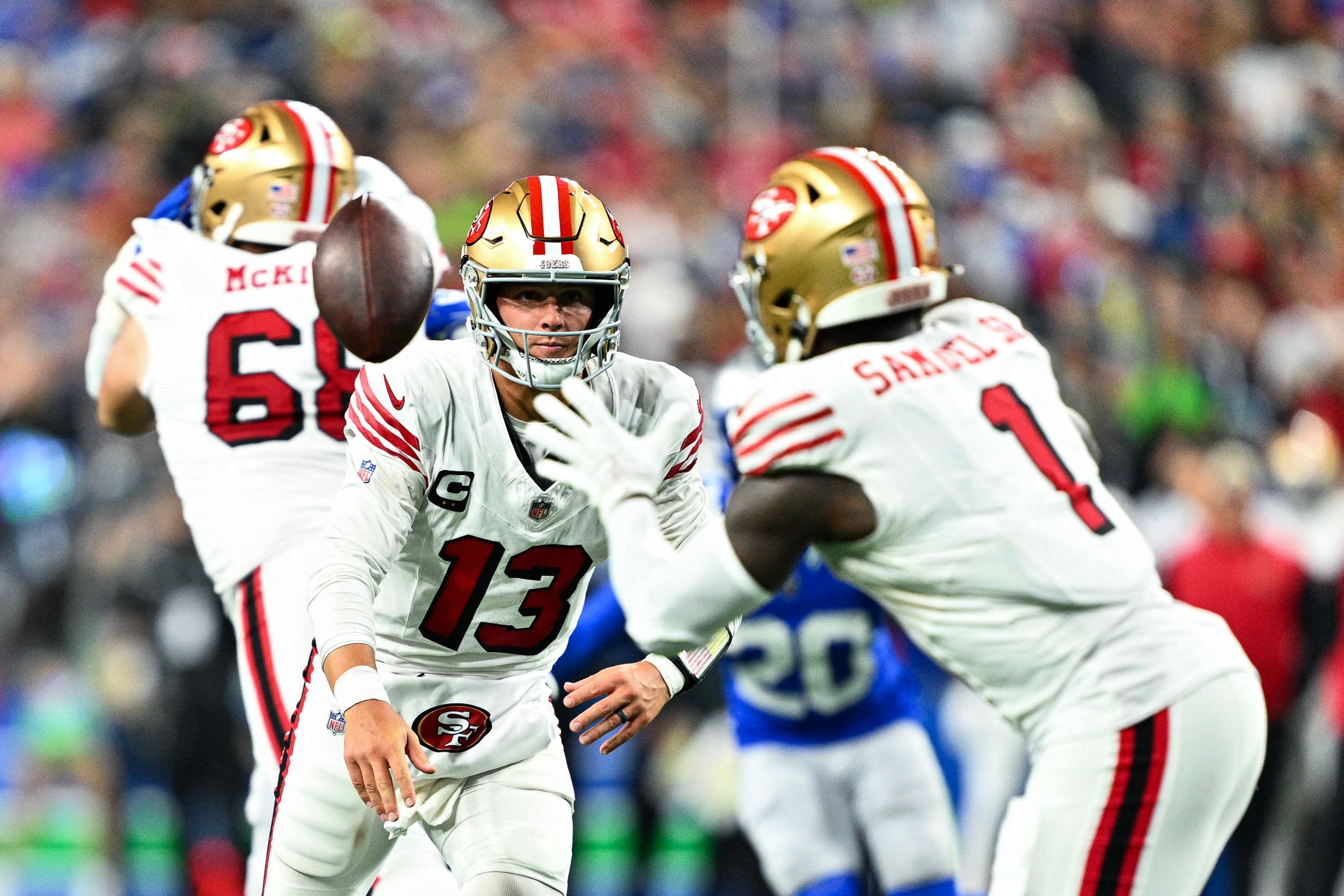 SEATTLE, WASHINGTON - OCTOBER 10: Brock Purdy #13 of the San Francisco 49ers tosses the ball to Deebo Samuel Sr. #1 during the fourth quarter against the Seattle Seahawks at Lumen Field on October 10, 2024 in Seattle, Washington.   Jane Gershovich/Getty Images/AFP (Photo by Jane Gershovich / GETTY IMAGES NORTH AMERICA / Getty Images via AFP)