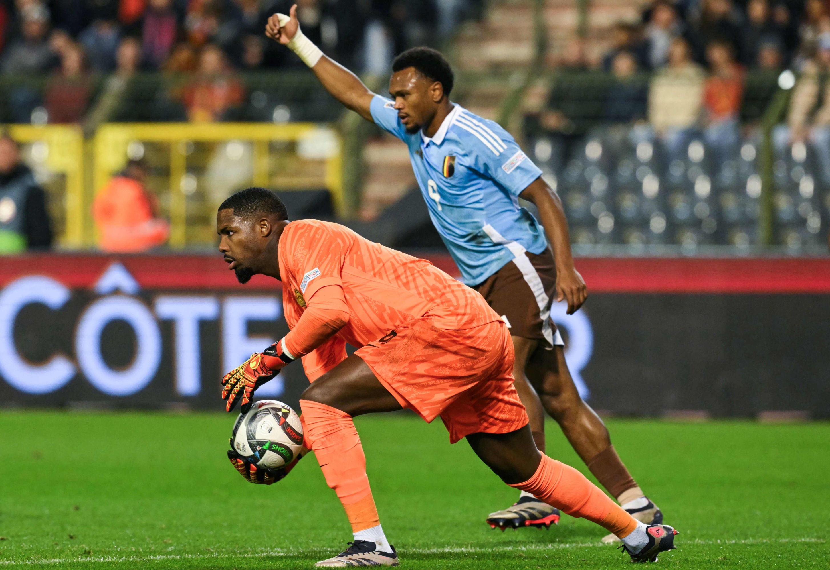 France's goalkeeper #16 Mike Maignan grabs the ball as Belgium's forward #09 Lois Openda gestures during the UEFA Nations League League A, Group A2 football match between Belgium and France, at the King Baudouin Stadium in Brussels, on October 14, 2024. (Photo by NICOLAS TUCAT / AFP)