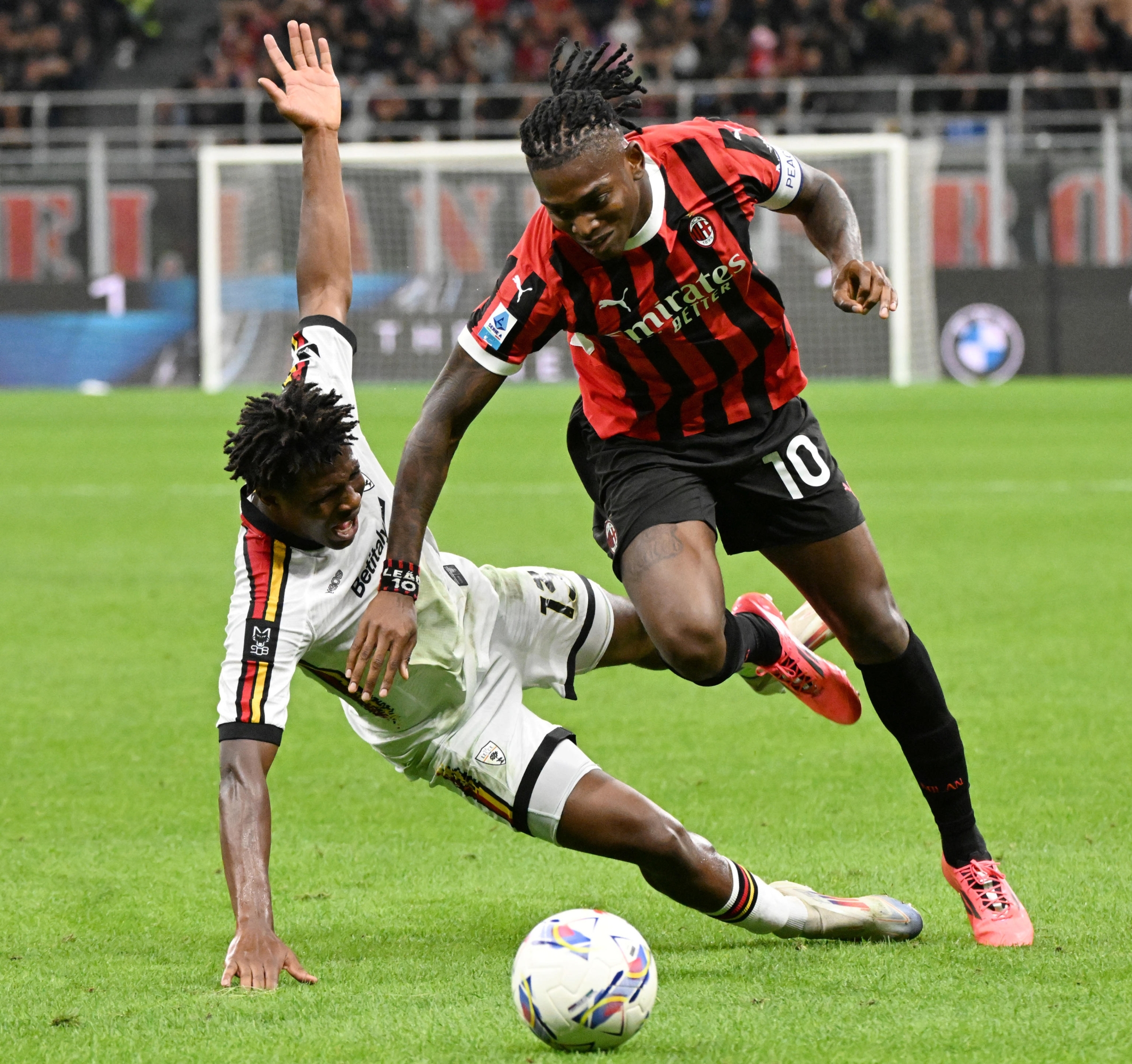 AC Milans forward Rafael Leao (R) and Lecces defender Patrick Dorgu struggle for the ball during their Italian Serie A soccer match at the Giuseppe Meazza stadium in Milan, Italy, 27 September 2024. ANSA/DANIEL DAL ZENNARO