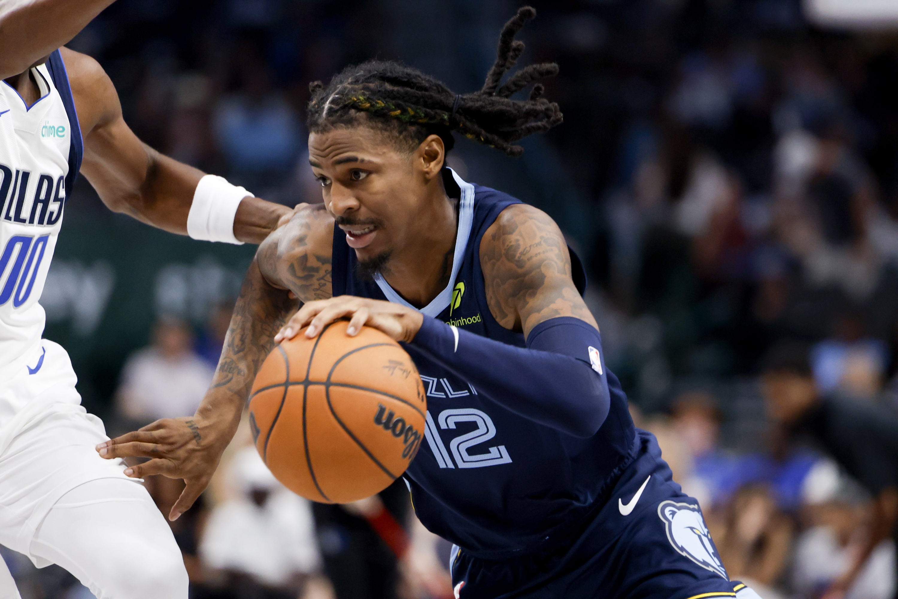 Memphis Grizzlies guard Ja Morant (12) drives past Dallas Mavericks guard Jazian Gortman (00) during an NBA preseason basketball game in Dallas, Monday, Oct. 7, 2024. (AP Photo/Gareth Patterson)    Associated Press / LaPresse Only italy and spain