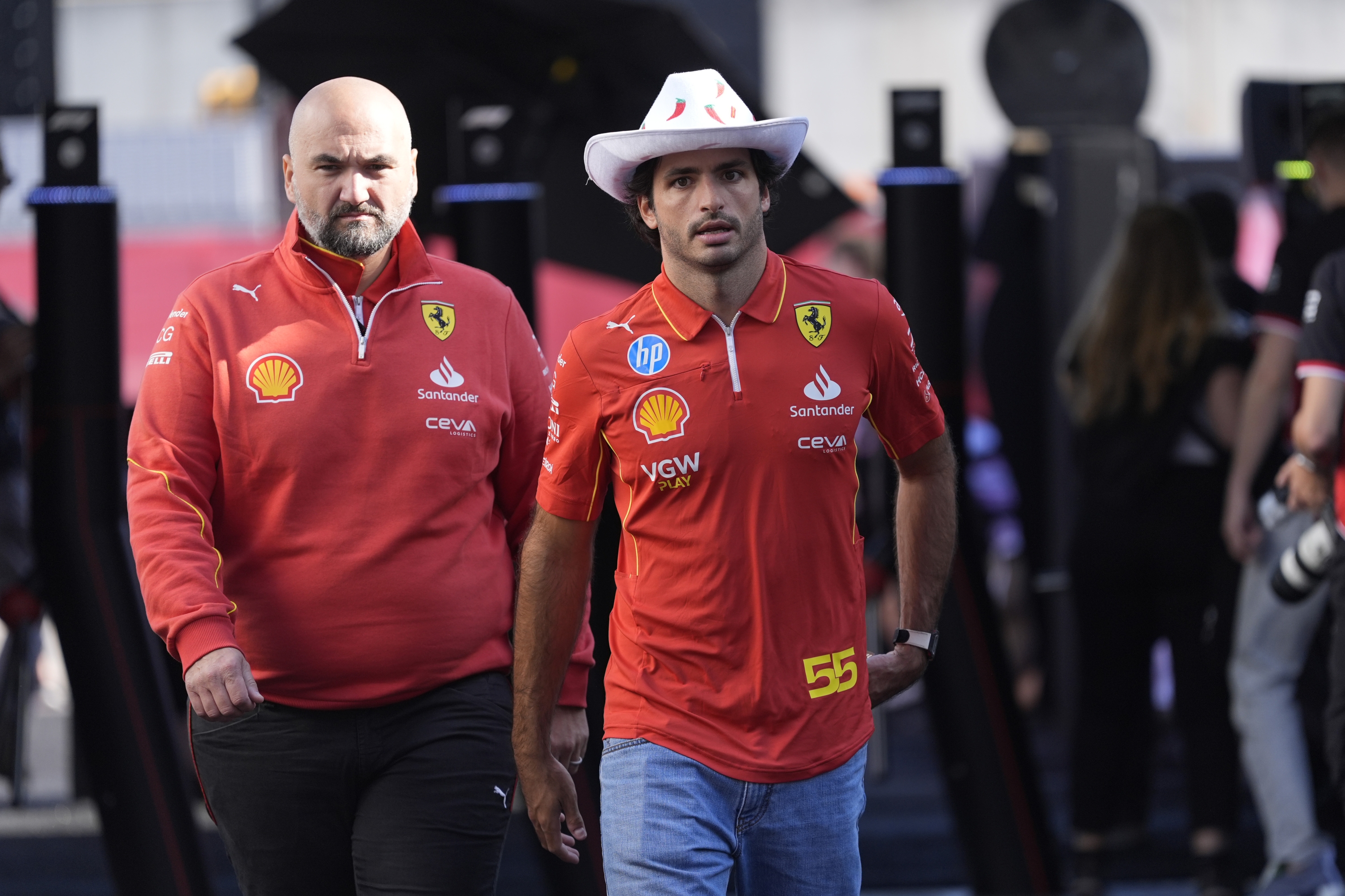 Ferrari driver Carlos Sainz, of Spain, arrives for a sprint race for the Formula One U.S. Grand Prix auto race at Circuit of the Americas, Saturday, Oct. 19, 2024, in Austin, Texas. (AP Photo/Eric Gay)