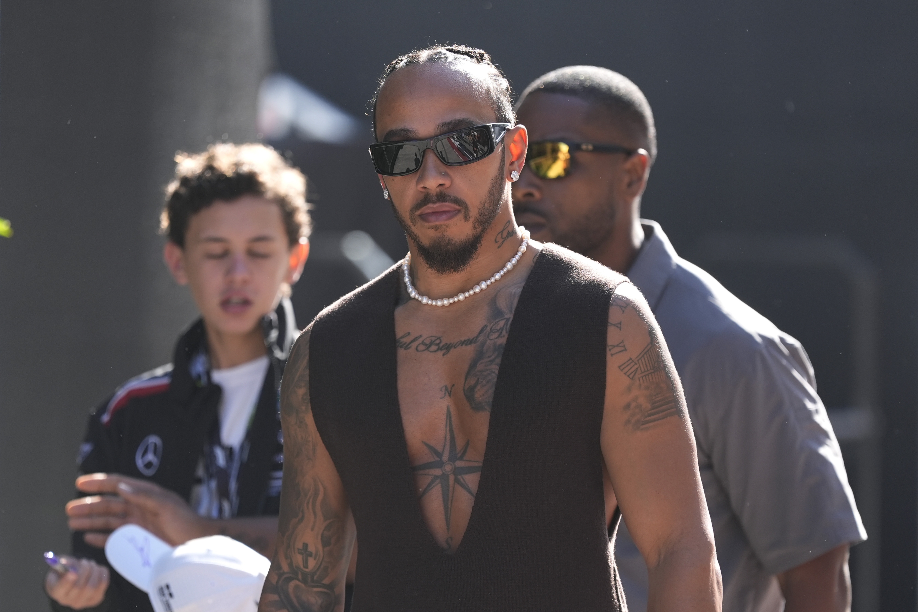 Mercedes driver Lewis Hamilton, of Britain, walks to his garage before a sprint race for the Formula One U.S. Grand Prix auto race at Circuit of the Americas, Saturday, Oct. 19, 2024, in Austin, Texas. (AP Photo/Eric Gay)