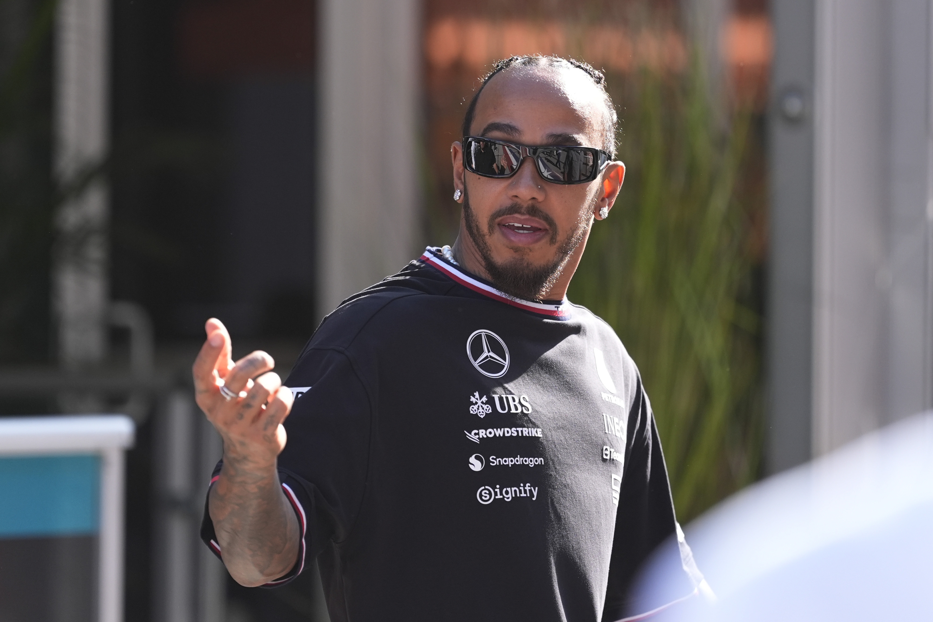 Mercedes driver Lewis Hamilton, of Britain, walks to his garage before a sprint race for the Formula One U.S. Grand Prix auto race at Circuit of the Americas, Saturday, Oct. 19, 2024, in Austin, Texas. (AP Photo/Eric Gay)