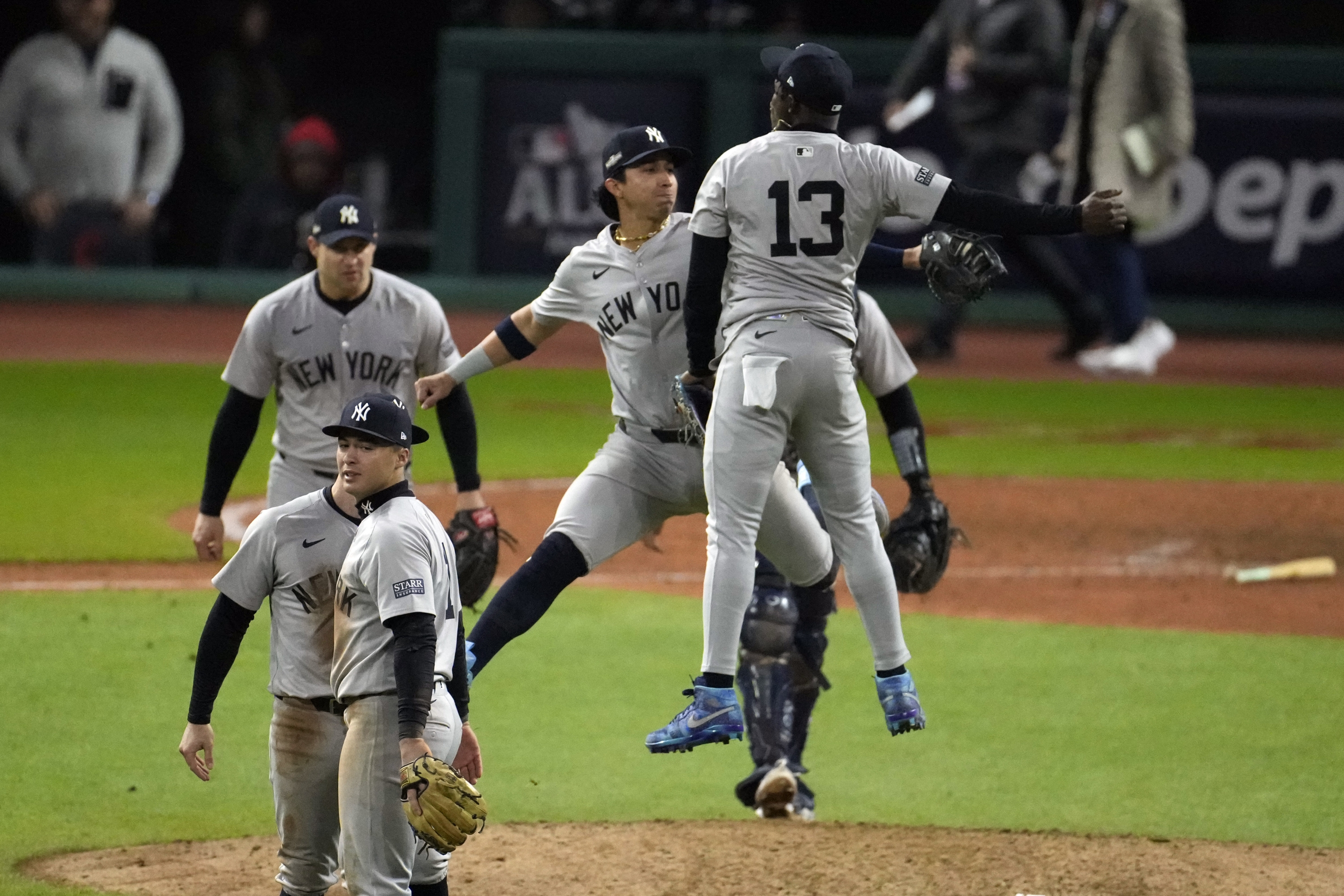 New York Yankees' Jazz Chisholm Jr. (13) and Oswaldo Cabrera celebrate after Game 4 of the baseball AL Championship Series against the Cleveland Guardians Friday, Oct. 18, 2024, in Cleveland. The Yankees won 8-6 to take a 3-1 lead in the best-of-seven series. (AP Photo/Jeff Roberson)