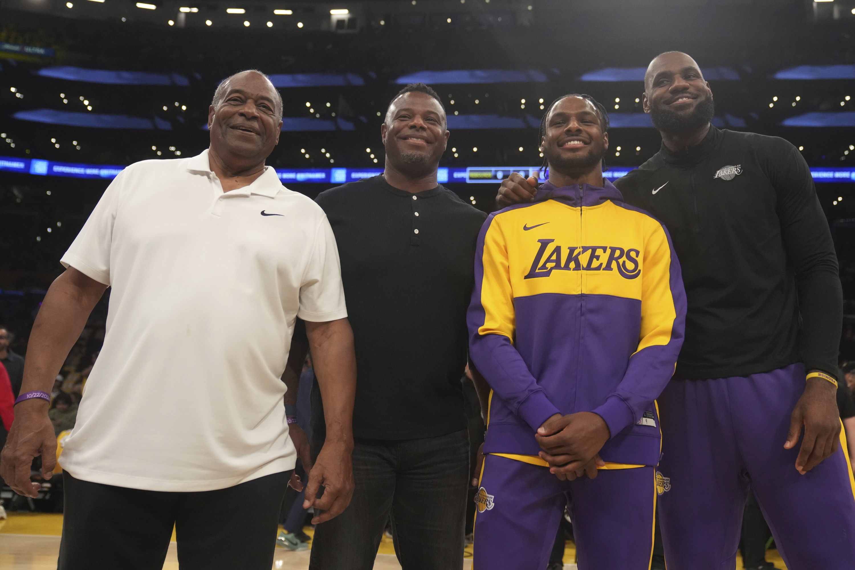 From left to right, Ken Griffey Sr., Ken Griffey Jr., Los Angeles Lakers guard Bronny James and forward LeBron James pose for a photo during an NBA basketball game against the Minnesota Timberwolves, Tuesday, Oct. 22, 2024, in Los Angeles. (AP Photo/Eric Thayer)