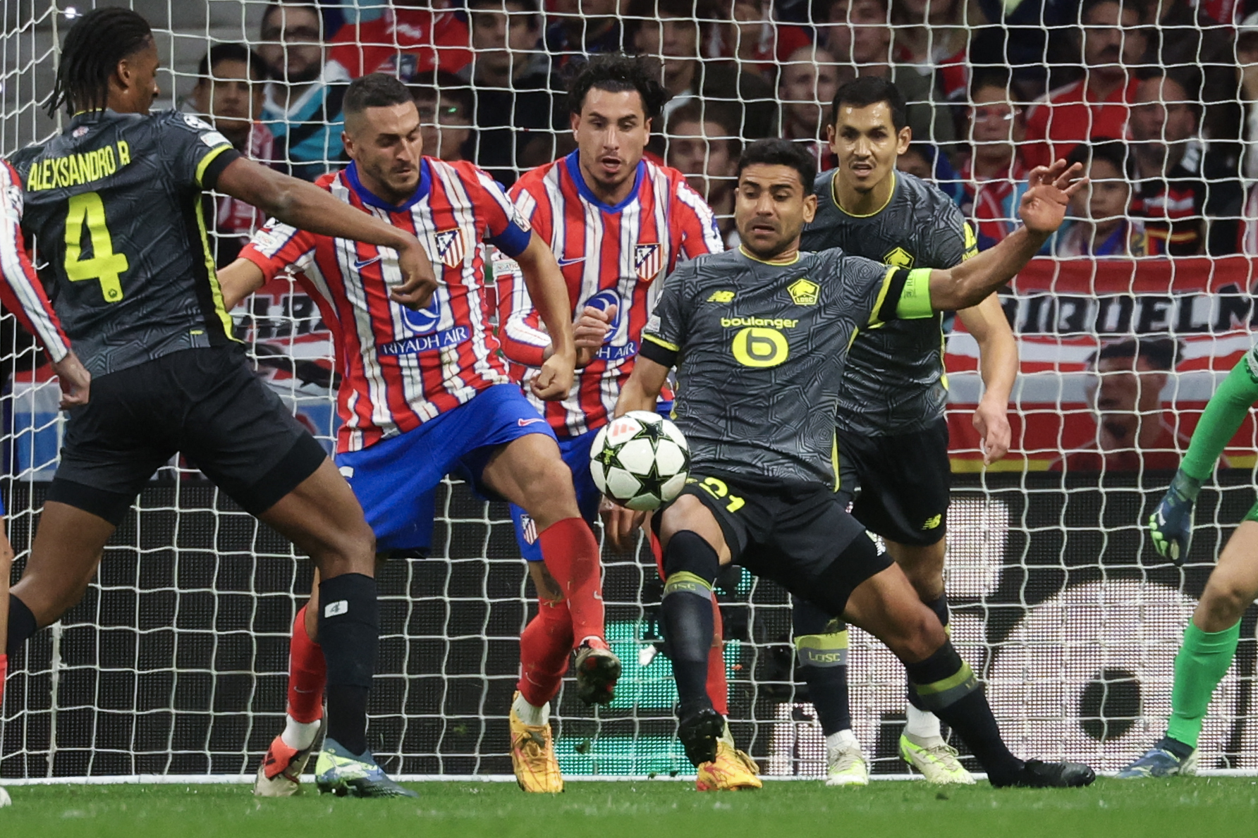 Atletico Madrid's Spanish midfielder #06 Koke (2L) and Lille's French midfielder #21 Benjamin Andre (2R) fight for the ball during the UEFA Champions League, league phase day 3 football match between Club Atletico de Madrid and Lille LOSC at the Metropolitano stadium in Madrid on October 23, 2024. (Photo by Pierre-Philippe MARCOU / AFP)