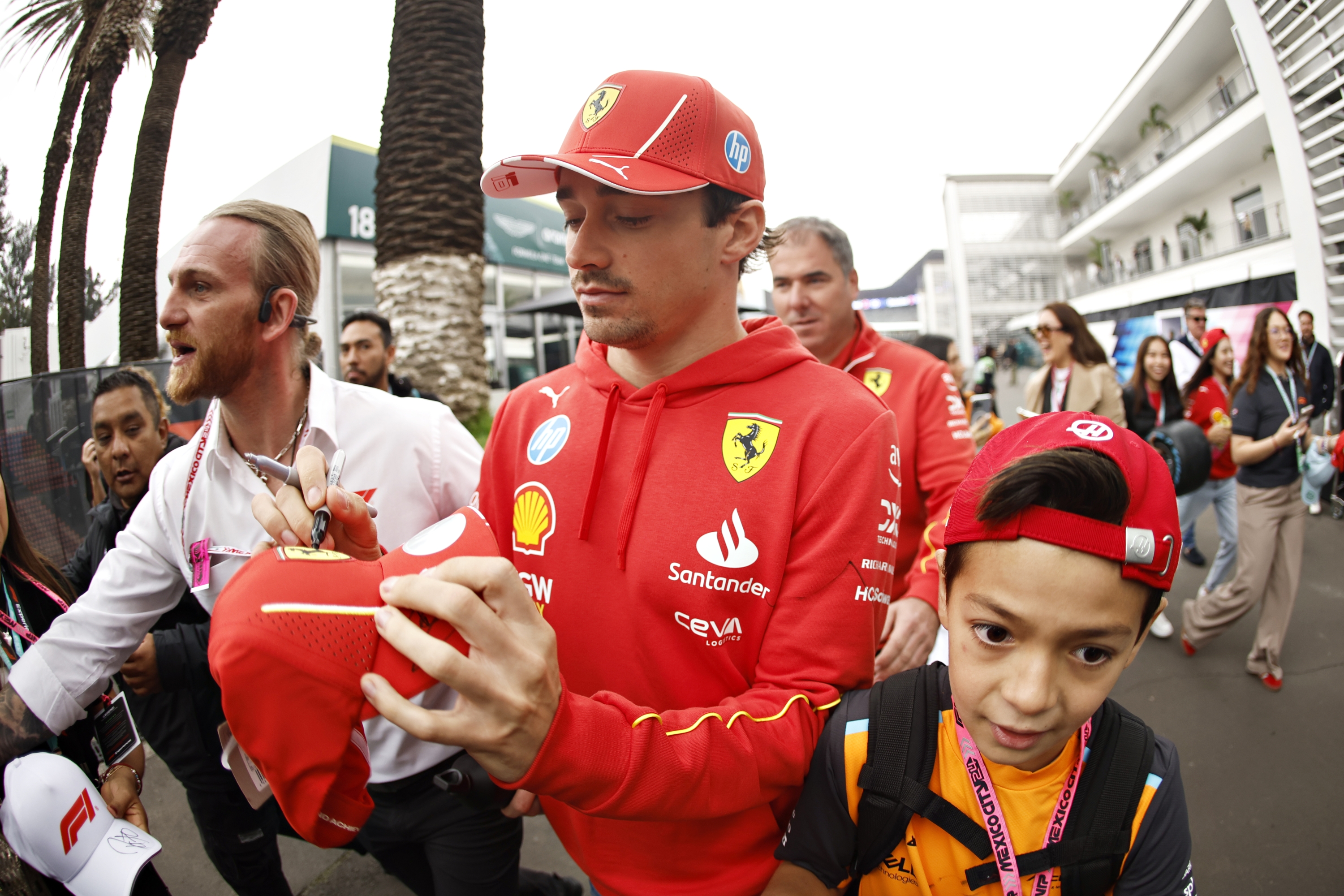 MEXICO CITY, MEXICO - OCTOBER 26: Charles Leclerc of Monaco and Ferrari signs autographs for fans in the Paddock prior to final practice ahead of the F1 Grand Prix of Mexico at Autodromo Hermanos Rodriguez on October 26, 2024 in Mexico City, Mexico. (Photo by Chris Graythen/Getty Images)