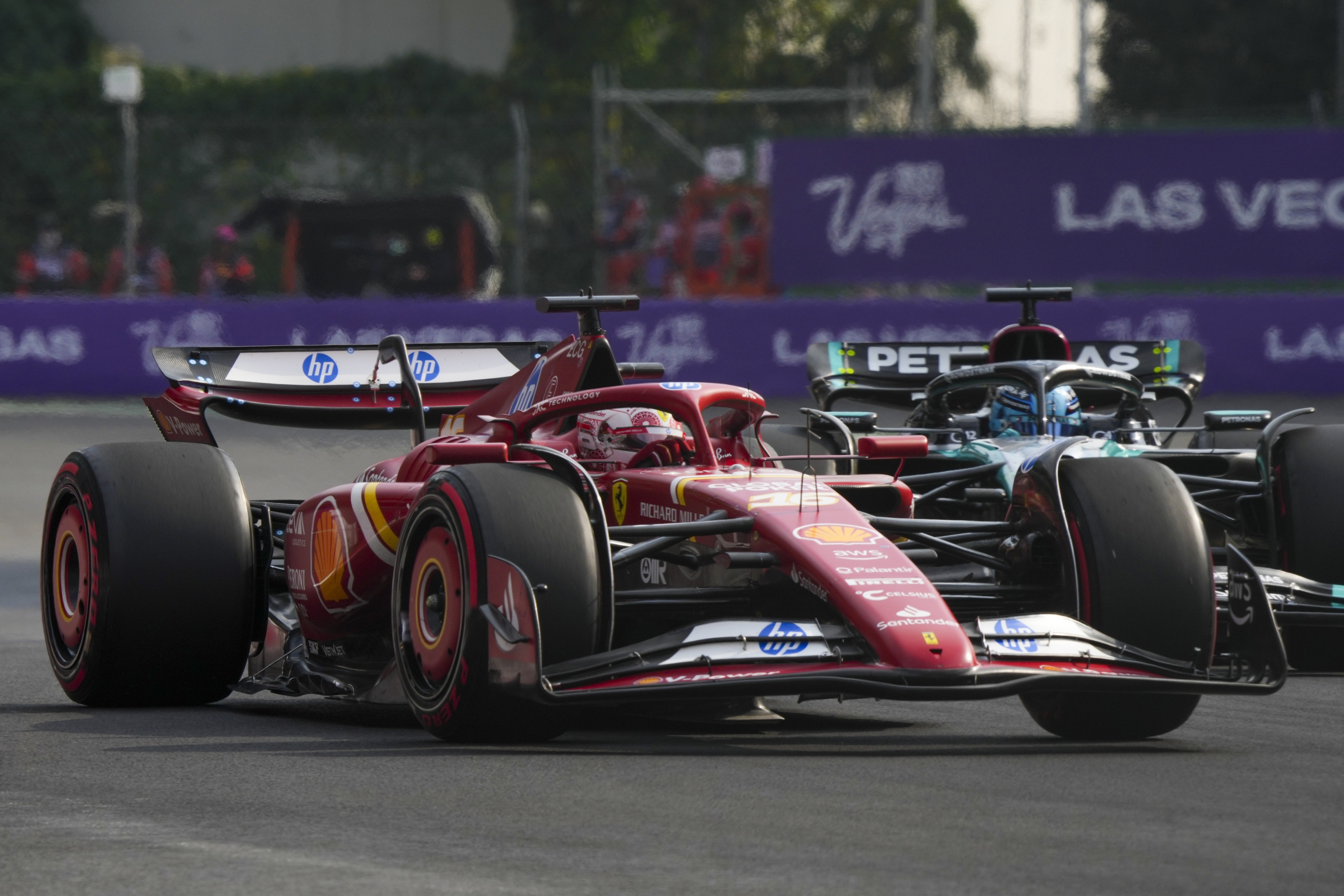 Ferrari driver Charles Leclerc, front left, of Monaco, and Mercedes driver George Russell, back right, of Britain, compete for the pole position during the Formula One Mexico Grand Prix auto race at the Hermanos Rodriguez racetrack in Mexico City, Saturday, Oct. 26, 2024. (AP Photo/Fernando Llano)