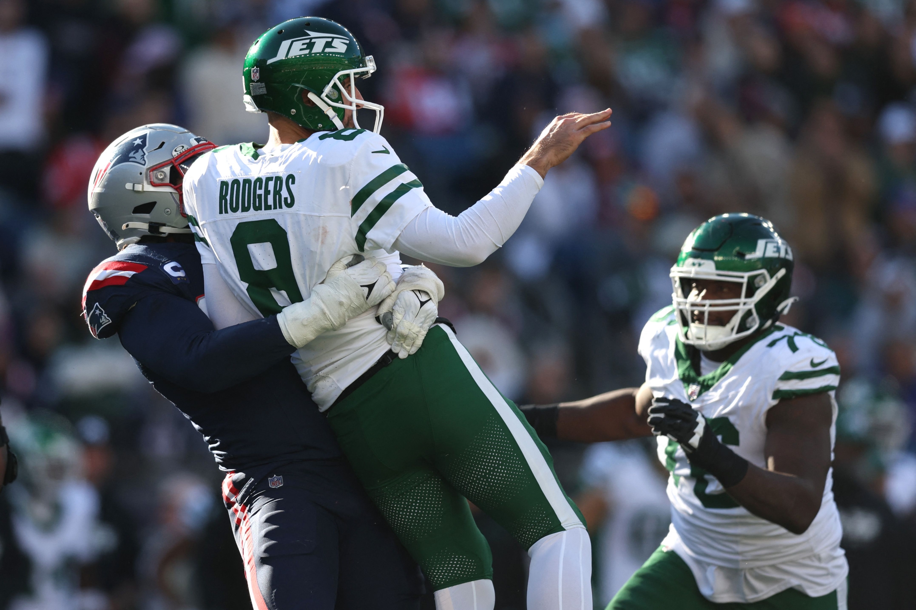 FOXBOROUGH, MASSACHUSETTS - OCTOBER 27: Deatrich Wise Jr. #91 of the New England Patriots sacks Aaron Rodgers #8 of the New York Jets during the third quarter at Gillette Stadium on October 27, 2024 in Foxborough, Massachusetts.   Adam Glanzman/Getty Images/AFP (Photo by Adam Glanzman / GETTY IMAGES NORTH AMERICA / Getty Images via AFP)