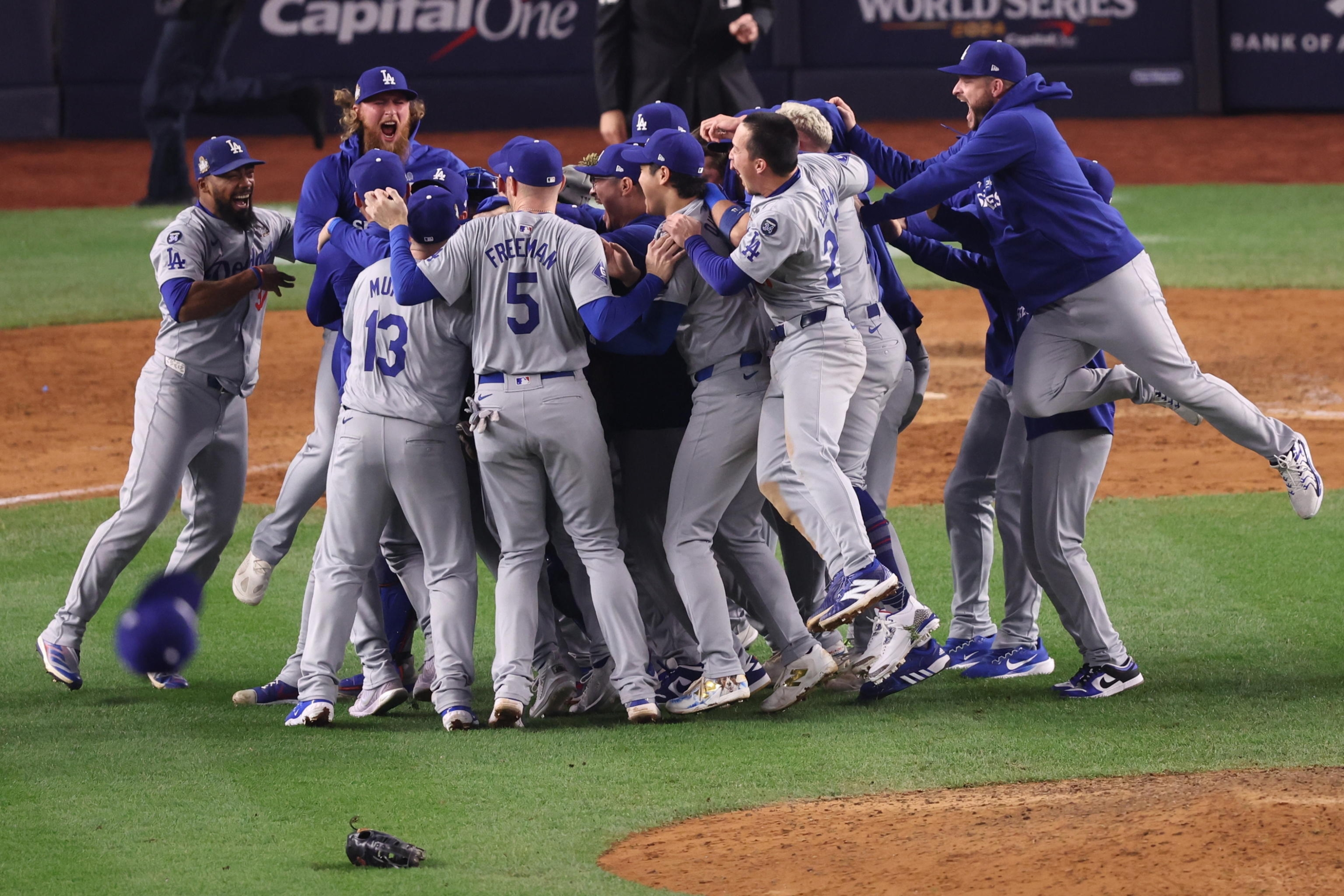 epa11693529 The Los Angeles Dodgers celebrate after the final out against the New York Yankees during game five to win the Major League Baseball (MLB) World Series at Yankees Stadium in the Bronx borough of New York, New York, USA, 30 October 2024.  EPA/SARAH YENESEL