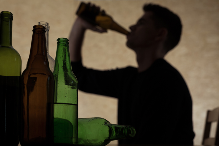 Alcoholism among young people - teenager drinking beer