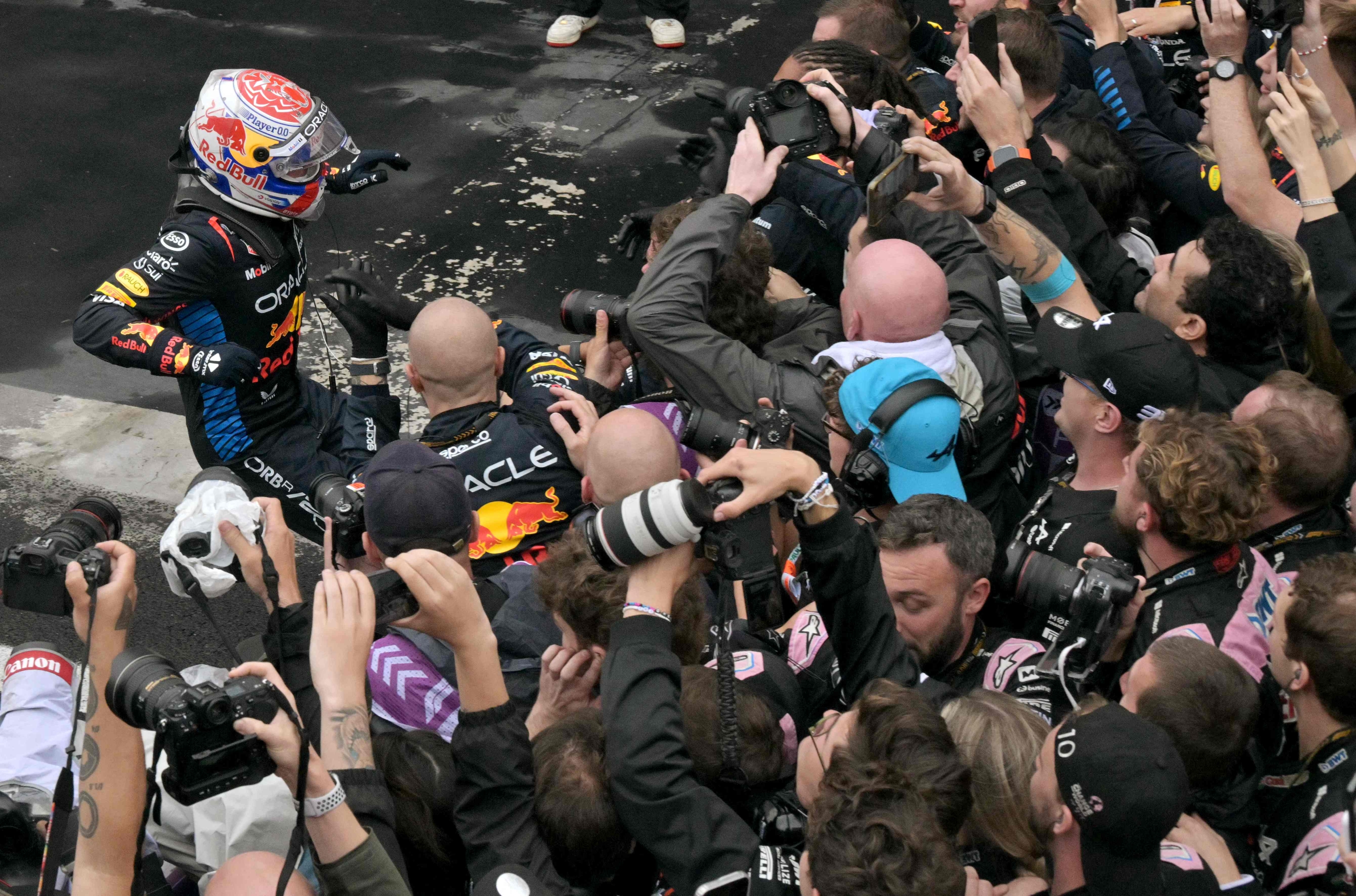 Red Bull Racing's Dutch driver Max Verstappen (L) celebrates after winning the Formula One Sao Paulo Grand Prix, at the Jose Carlos Pace racetrack, aka Interlagos, in Sao Paulo, Brazil, on November 3, 2024. (Photo by NELSON ALMEIDA / AFP)