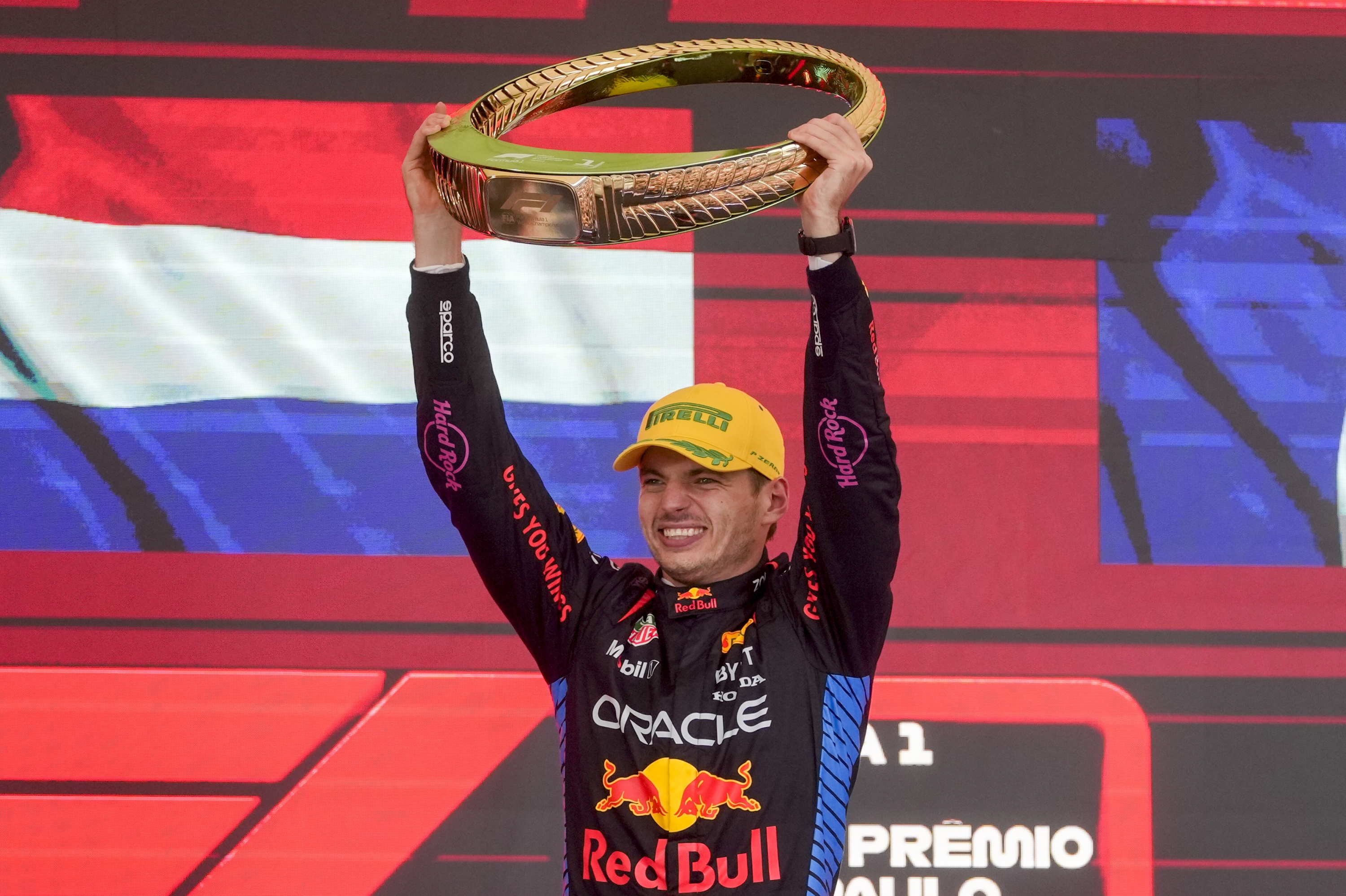 Red Bull driver Max Verstappen, of the Netherlands, celebrates on the podium his first place in the Brazilian Formula One Grand Prix at the Interlagos race track in Sao Paulo, Sunday, Nov. 3, 2024. (AP Photo/Andre Penner)