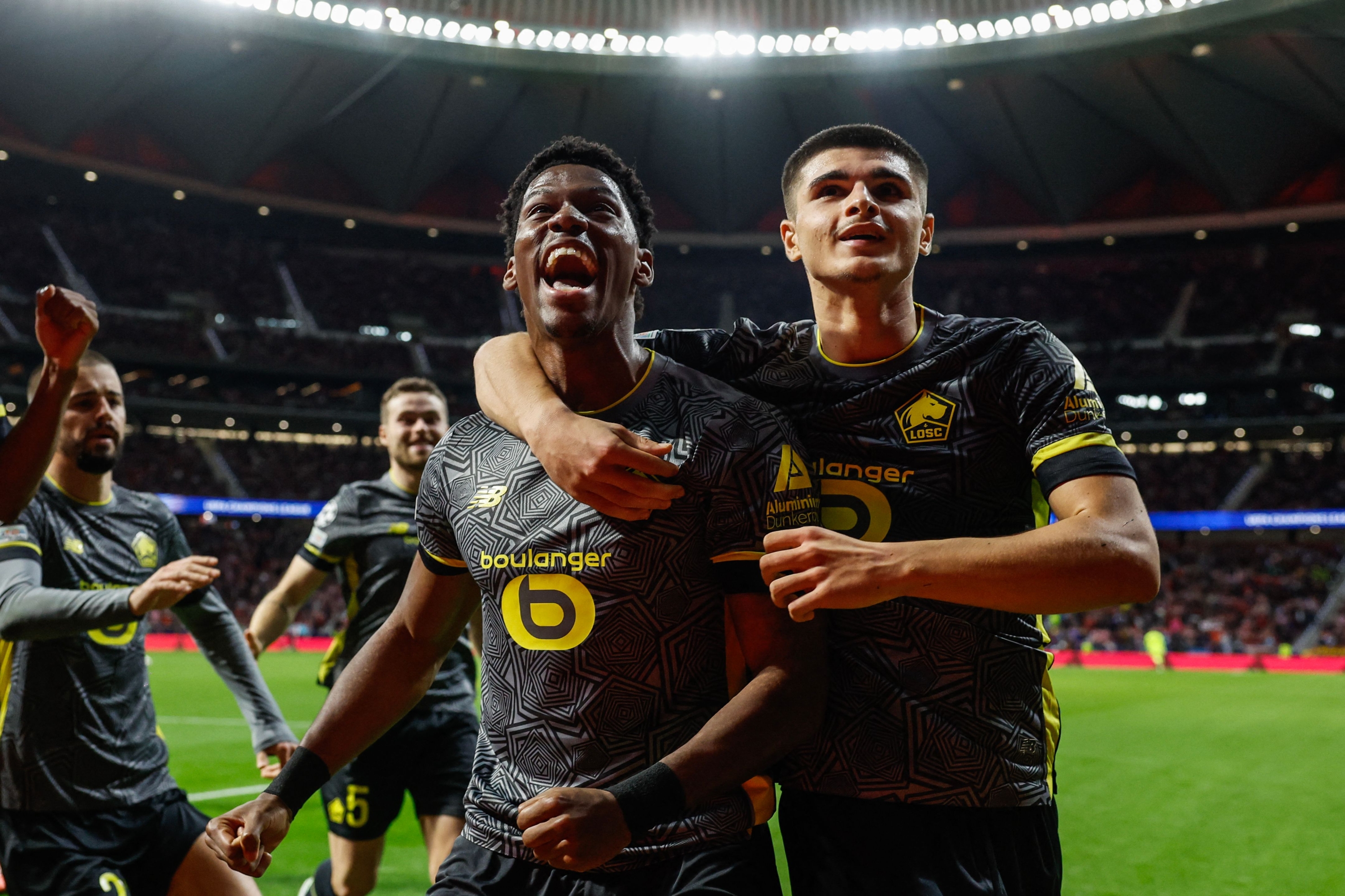 Lille's Canadian forward #09 Jonathan David (2R) celebrates scoring his team's second goal during the UEFA Champions League, league phase day 3 football match between Club Atletico de Madrid and Lille LOSC at the Metropolitano stadium in Madrid on October 23, 2024. (Photo by OSCAR DEL POZO / AFP)