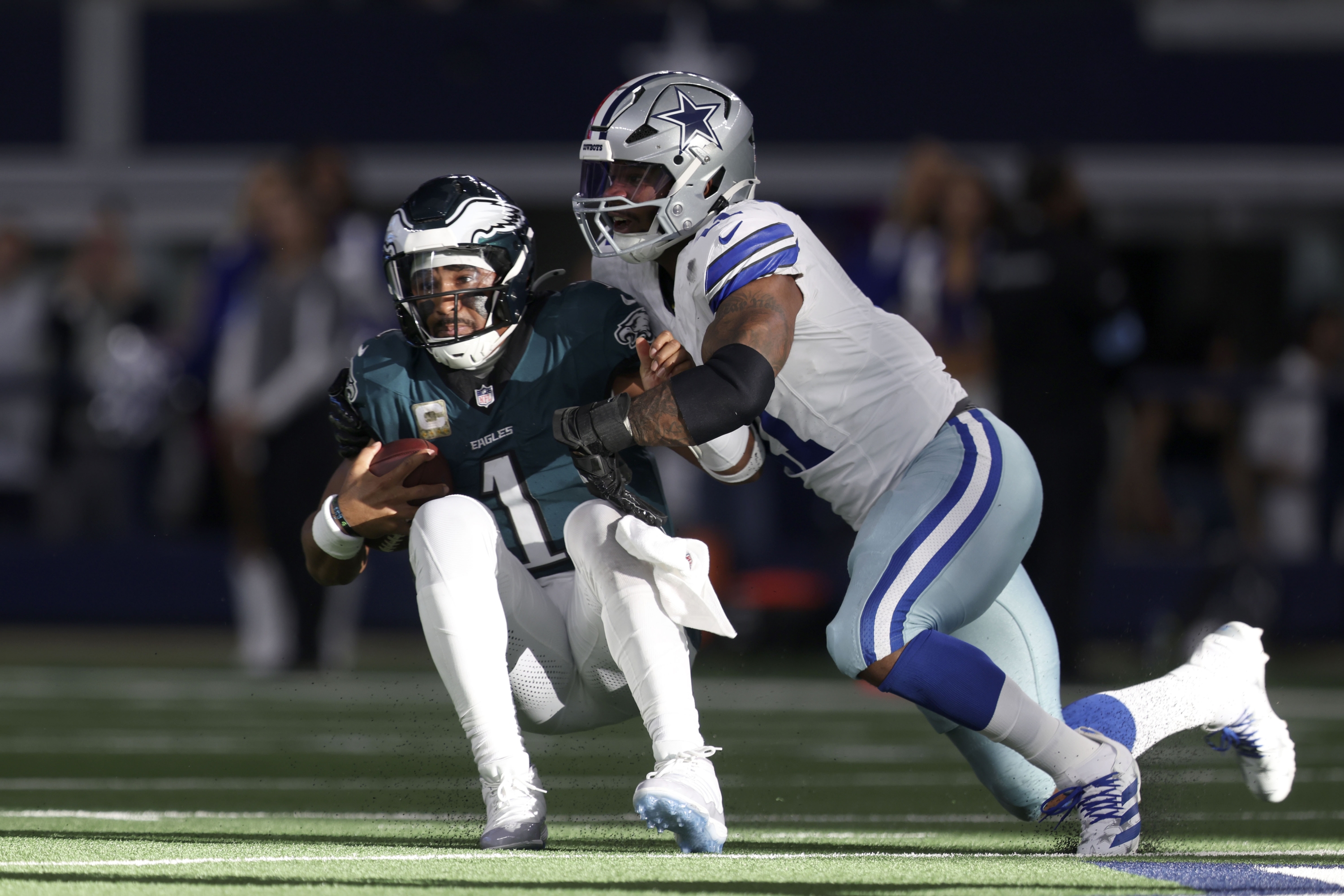 Philadelphia Eagles quarterback Jalen Hurts (1) is sacked by Dallas Cowboys linebacker Micah Parsons, right, in the first half of an NFL football game in Arlington, Texas, Sunday, Nov. 10, 2024. (AP Photo/Gareth Patterson)