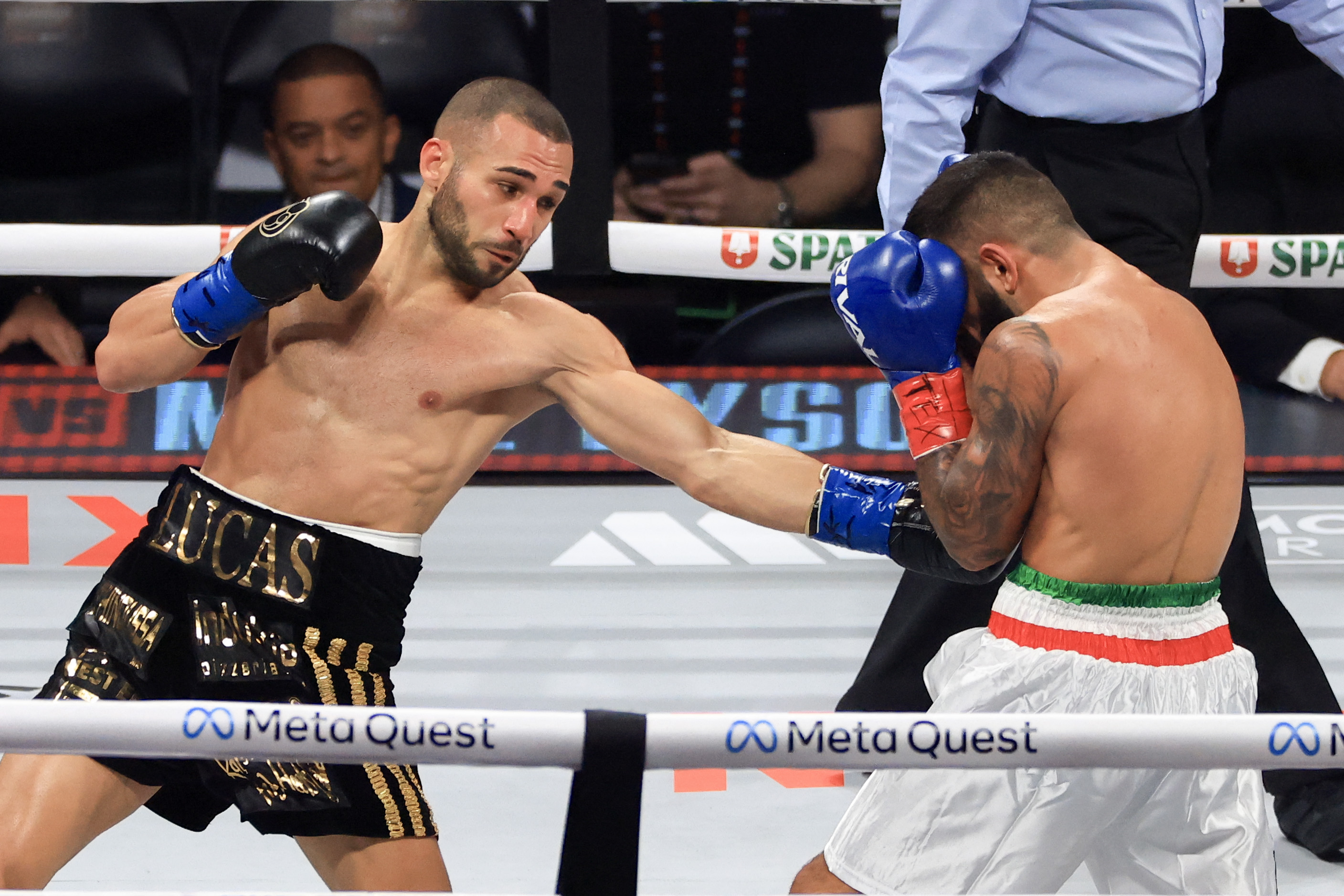 ARLINGTON, TEXAS - NOVEMBER 15: Lucas Bahdi (L) punches Armando Casamonica during their lightweight bout at AT&T Stadium on November 15, 2024 in Arlington, Texas.   Christian Petersen/Getty Images/AFP (Photo by Christian Petersen / GETTY IMAGES NORTH AMERICA / Getty Images via AFP)