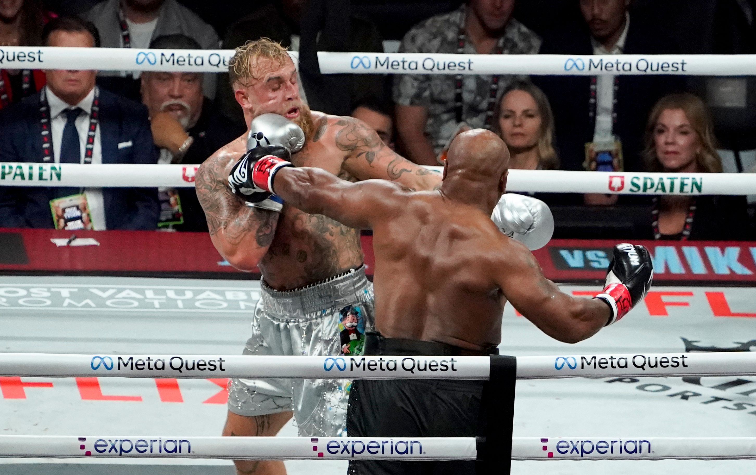 TOPSHOT - US retired pro-boxer Mike Tyson (R) and US YouTuber/boxer Jake Paul (L) fight during the heavyweight boxing bout at The Pavilion at AT&T Stadium in Arlington, Texas, November 15, 2024. (Photo by TIMOTHY A. CLARY / AFP)