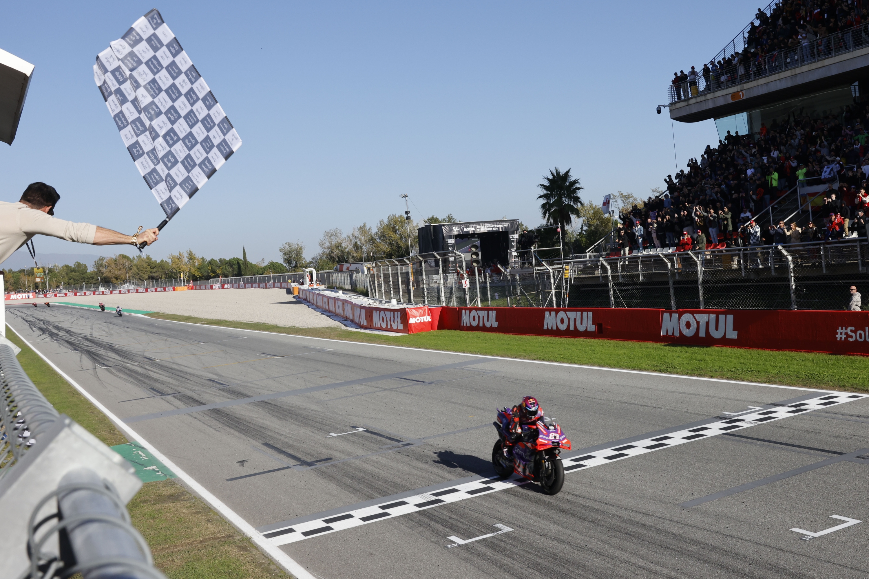 Moto GP World Champion winner Spain's rider Jorge Martin of the Prima Pramac Racing crosses the finish line after finishing third during the MotoGP race of the Grand Prix of Barcelona at the Catalunya racetrack in Montmelo, just outside of Barcelona, Spain, Sunday, Nov. 17, 2024. (AP Photo/Joan Monfort)