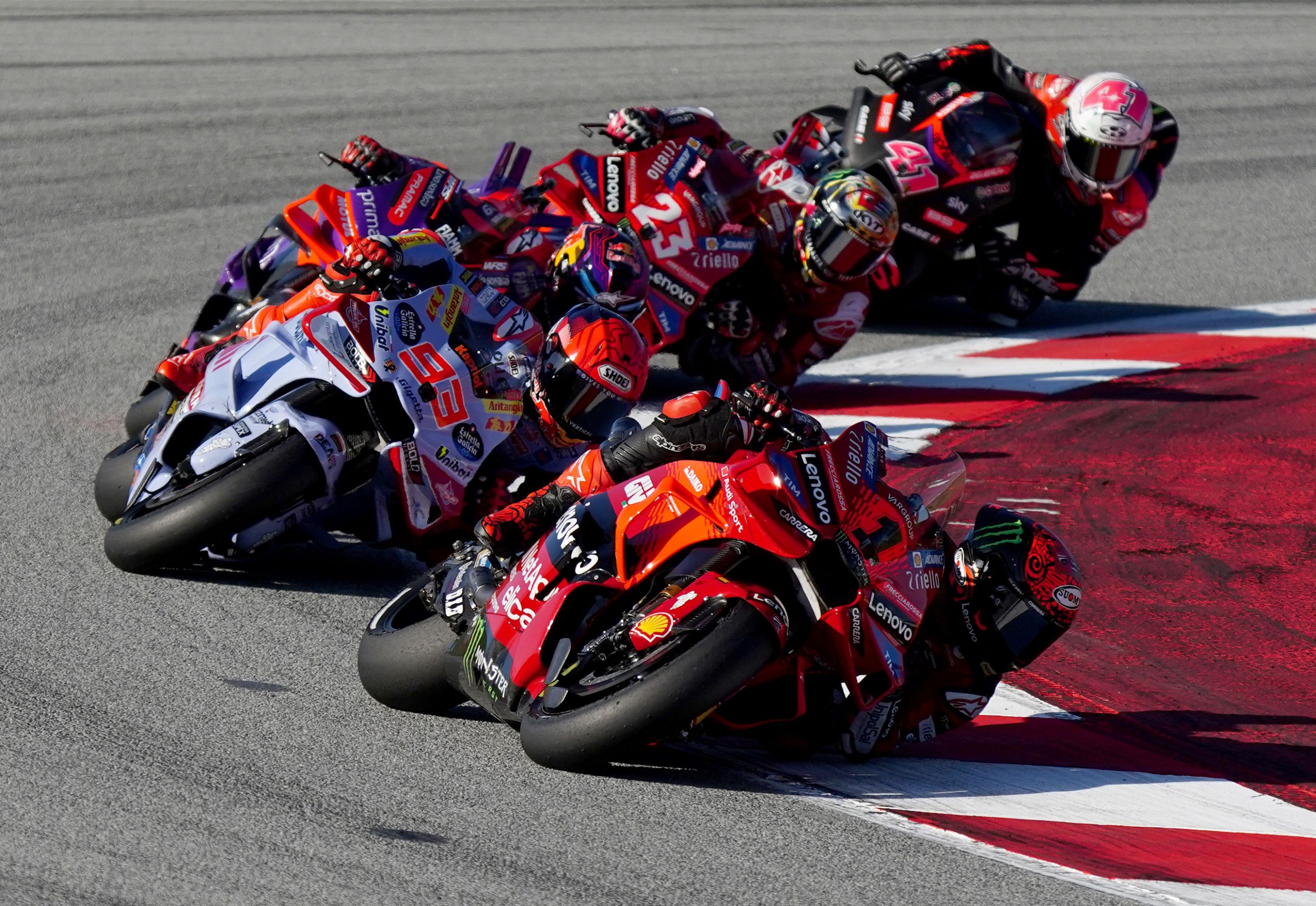 TOPSHOT - Ducati Italian rider Francesco Bagnaia (R) followed by Ducati Spanish rider Marc Marquez and Ducati Spanish rider Jorge Martin (L) compete during the MotoGP Solidarity Grand Prix of Barcelona at the Circuit de Catalunya on November 17, 2024 in Montmelo on the outskirts of Barcelona. (Photo by Manaure Quintero / AFP)