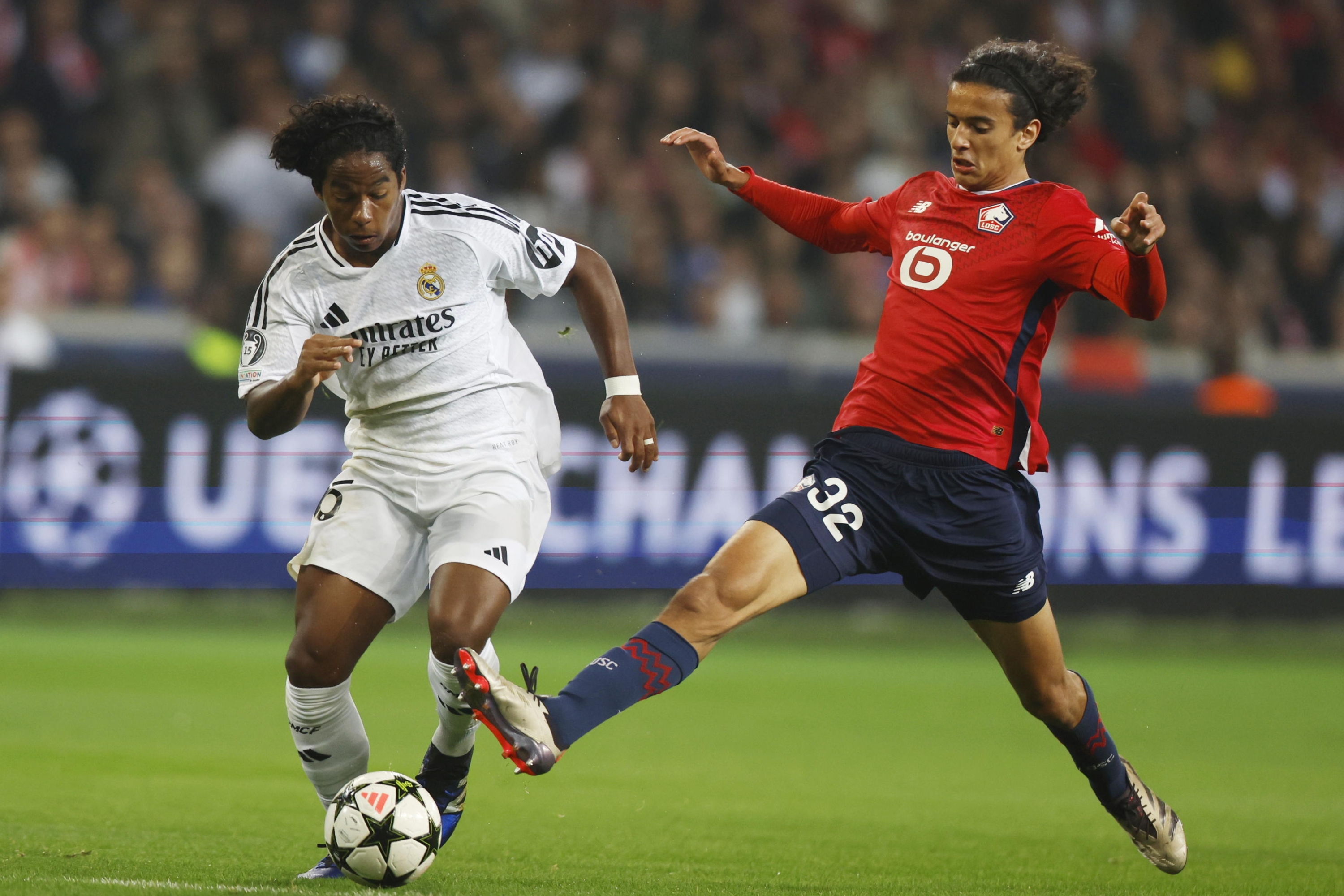 epa11638577 Ayyoub Bouaddi (R) of Lille in action against Endrick of Real Madrid during the UEFA Champions League match between Lille and Real Madrid in Lille, France, 02 October 2024.  EPA/MOHAMMED BADRA