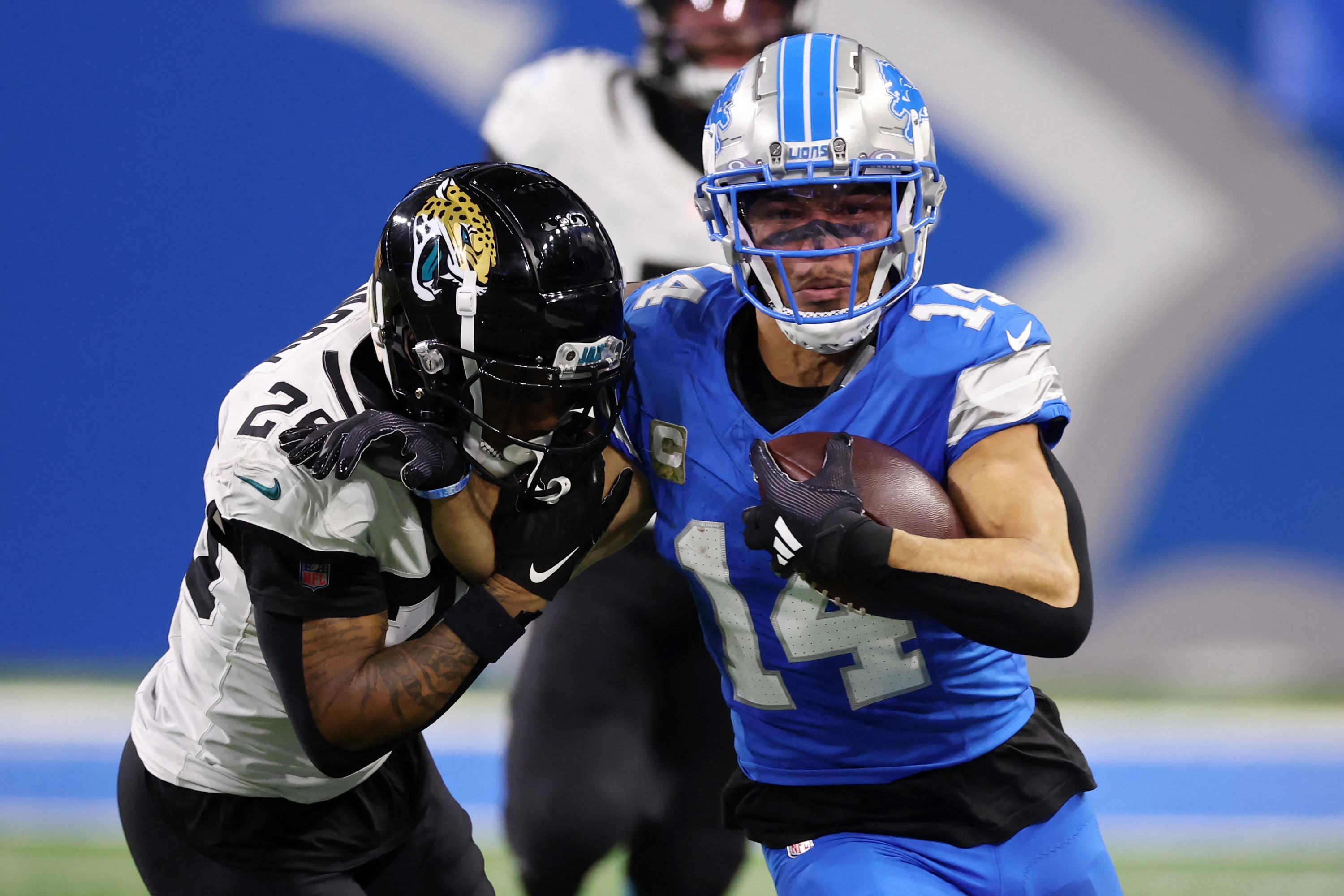 DETROIT, MICHIGAN - NOVEMBER 17: Amon-Ra St. Brown #14 of the Detroit Lions tries to avoid being tackled by Ronald Darby #25 of the Jacksonville Jaguars in the third quarter of a game at Ford Field on November 17, 2024 in Detroit, Michigan.   Gregory Shamus/Getty Images/AFP (Photo by Gregory Shamus / GETTY IMAGES NORTH AMERICA / Getty Images via AFP)