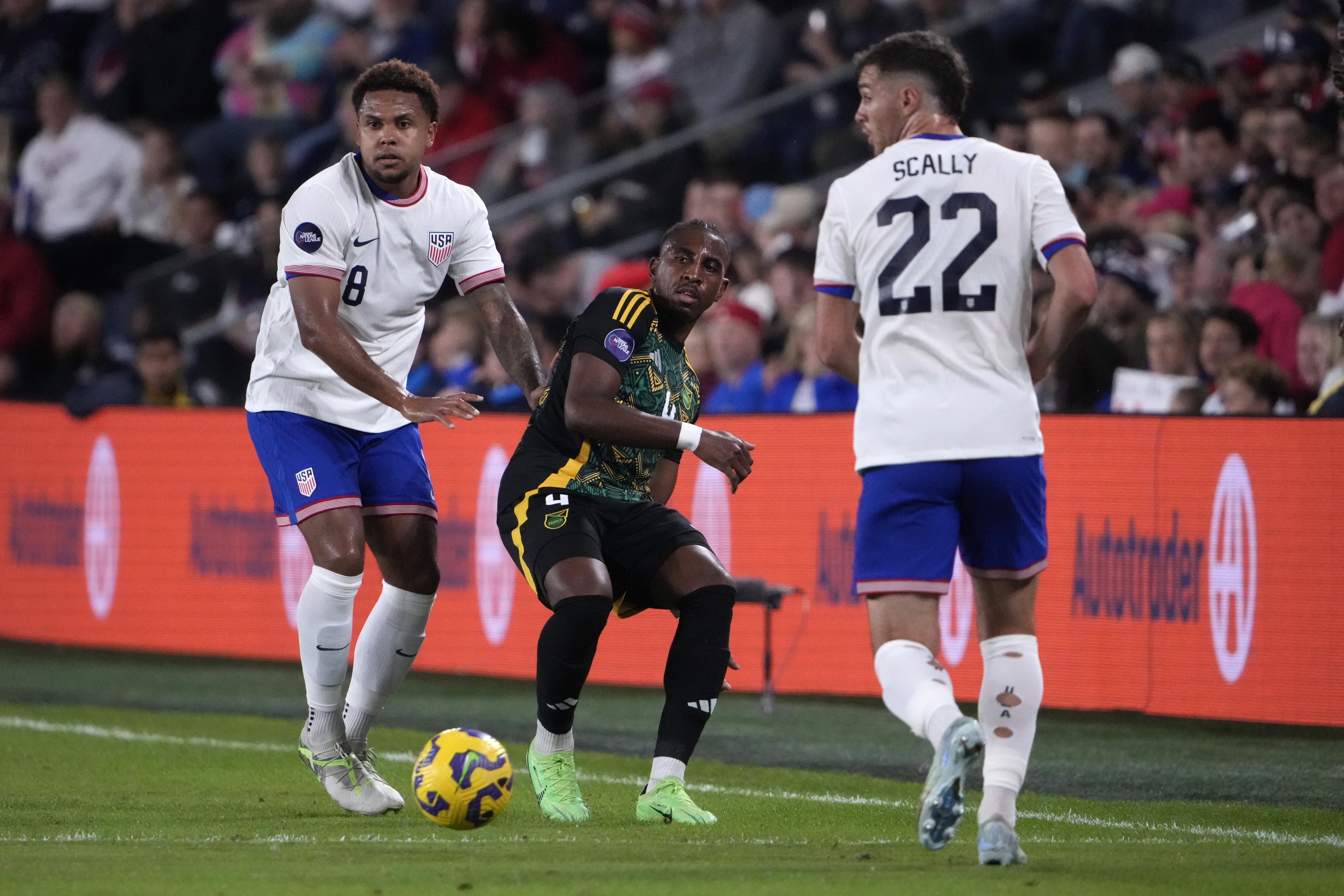 Jamaica's Amari'i Bell passes between United States' Weston McKennie (8) and Joe Scally (22) during the first half in a CONCACAF Nations League quarterfinal second leg soccer match Monday, Nov. 18, 2024, in St. Louis. (AP Photo/Jeff Roberson)