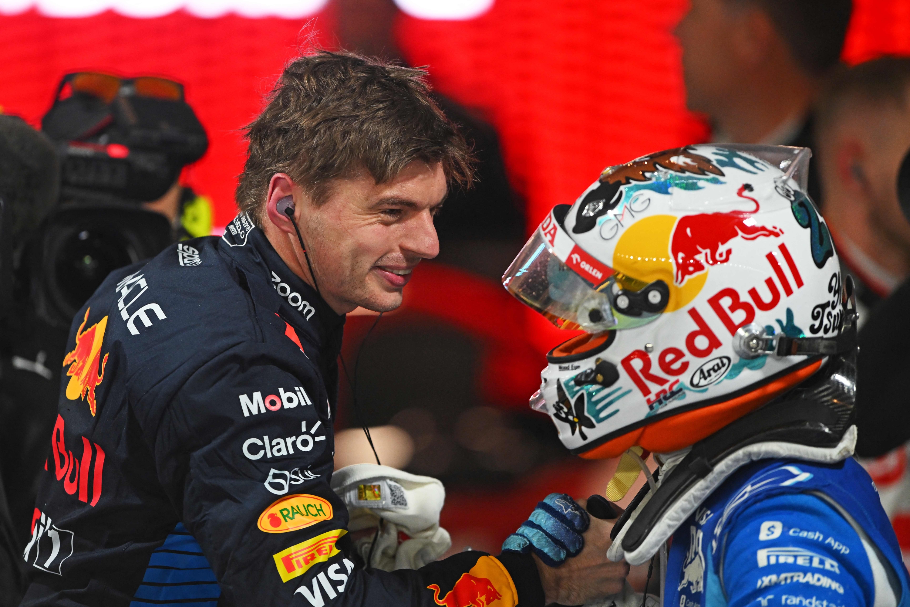 LAS VEGAS, NEVADA - NOVEMBER 23: 2024 F1 World Drivers Champion Max Verstappen of the Netherlands and Oracle Red Bull Racing is congratulated by 9th placed finisher Yuki Tsunoda of Japan and Visa Cash App RB in parc ferme during the F1 Grand Prix of Las Vegas at Las Vegas Strip Circuit on November 23, 2024 in Las Vegas, Nevada.   Rudy Carezzevoli/Getty Images/AFP (Photo by Rudy Carezzevoli / GETTY IMAGES NORTH AMERICA / Getty Images via AFP)