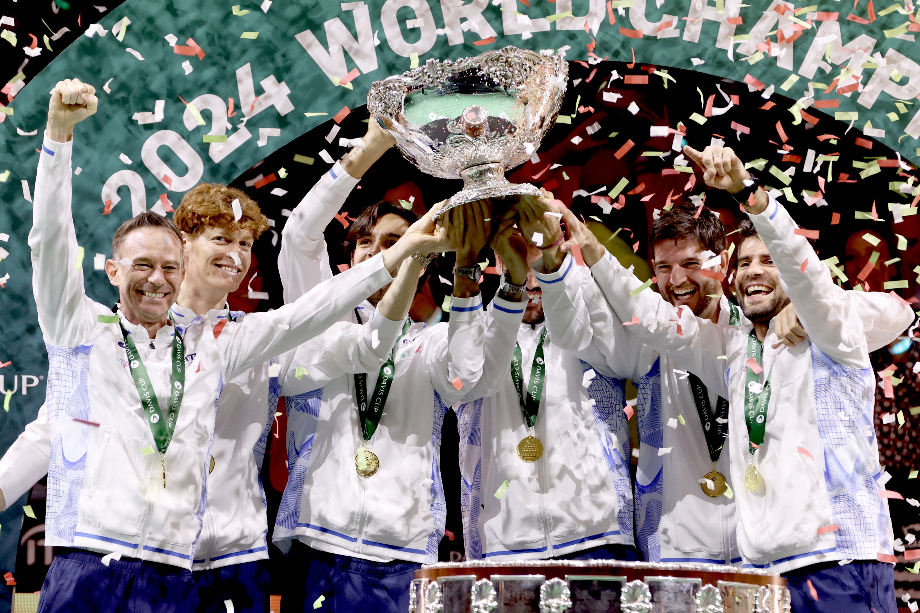 MALAGA, SPAIN - NOVEMBER 24: (L-R) Filippo Volandri, Jannik Sinner, Lorenzo Musetti, Matteo Berrettini, Andrea Vavassori and Simone Bolelli of Italy lift the Davis Cup Trophy after their teams victory during the Davis Cup Final match against Netherlands during the Davis Cup Finals at Palacio de Deportes Jose Maria Martin Carpena on November 24, 2024 in Malaga, Spain. (Photo by Clive Brunskill/Getty Images for ITF)